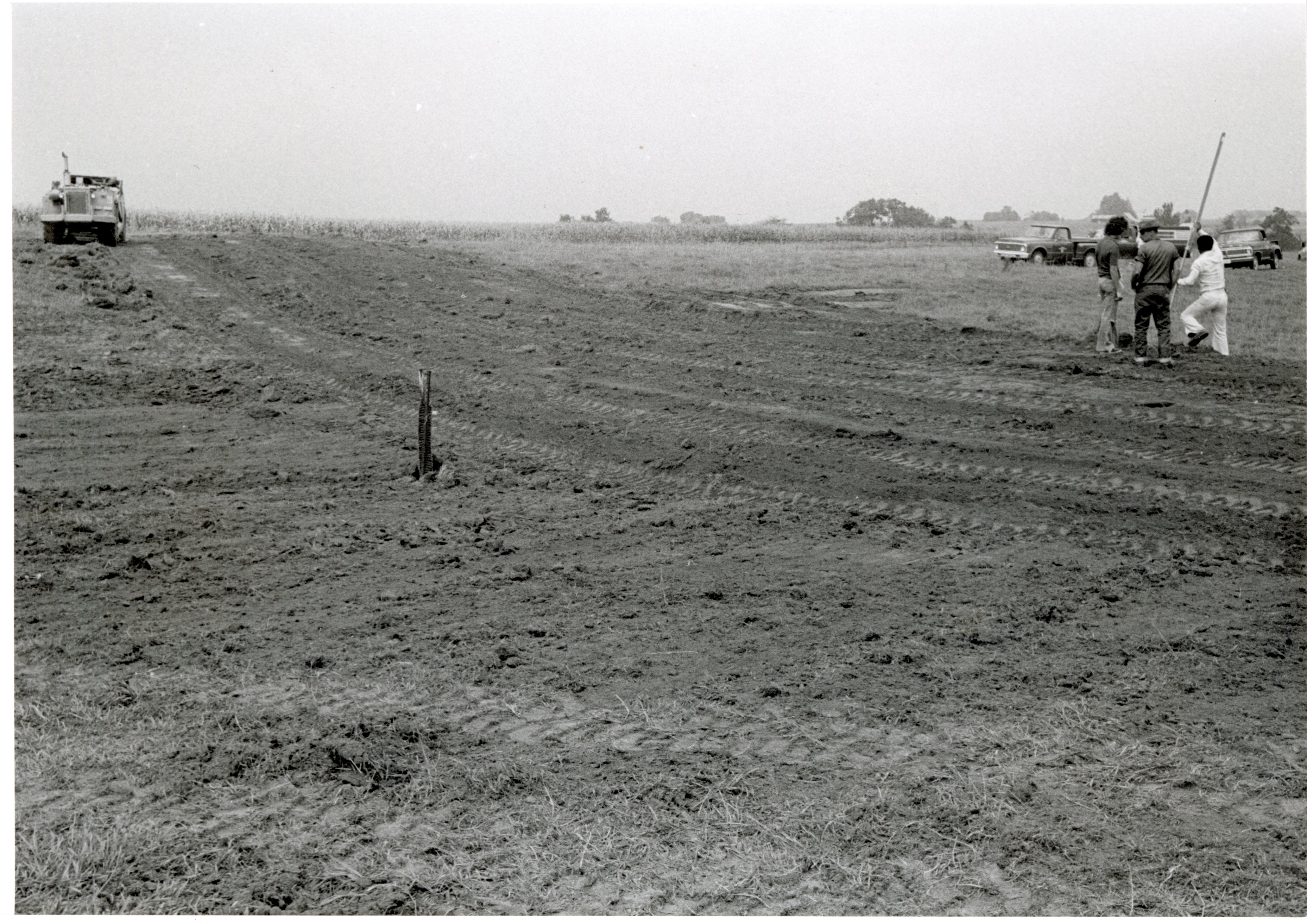 Bulldozed field with water drainage pipes
