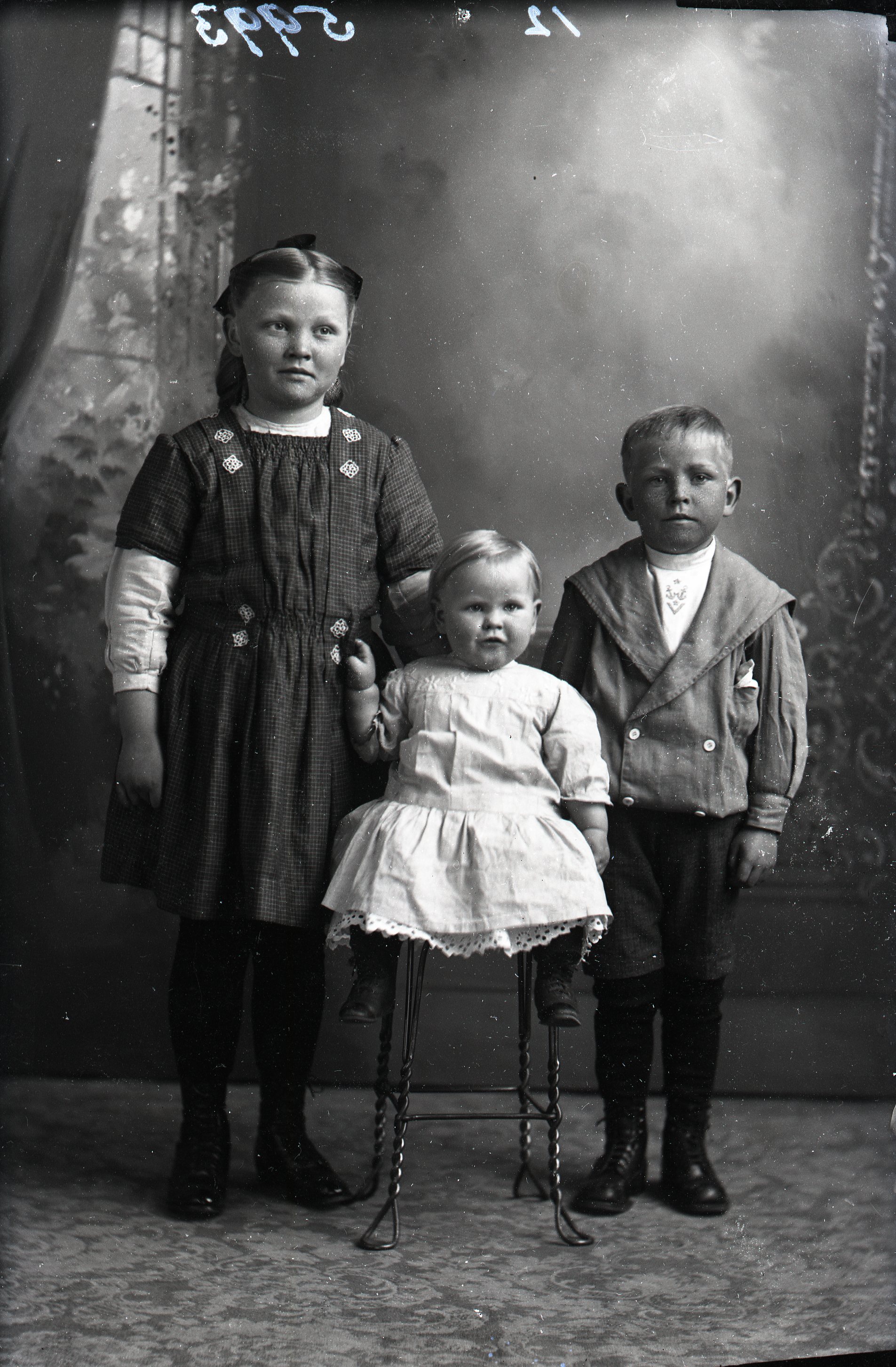 Three children (girl, boy, infant)
