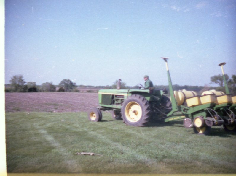 Man on Tractor Pulling Trailer with Chemicals