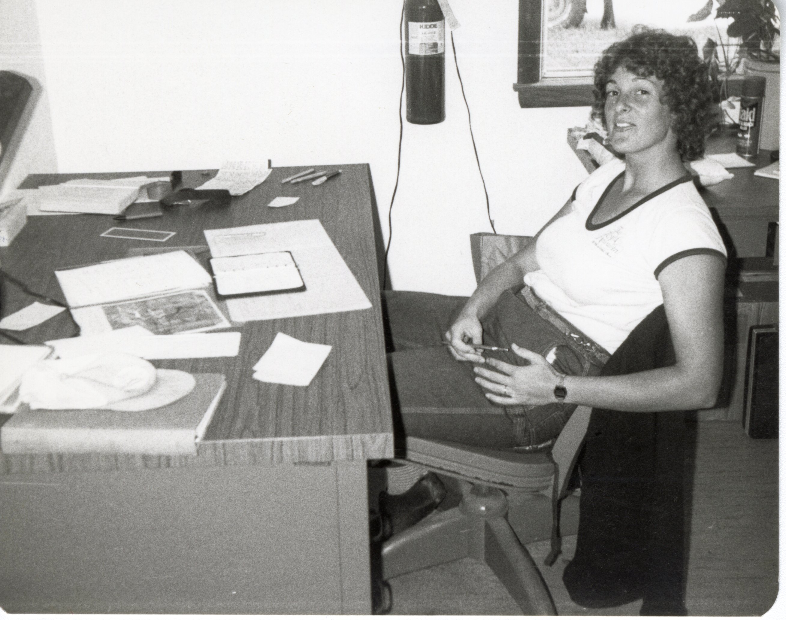Soil Conservqtion worker Julie Falon Sits at office Desk