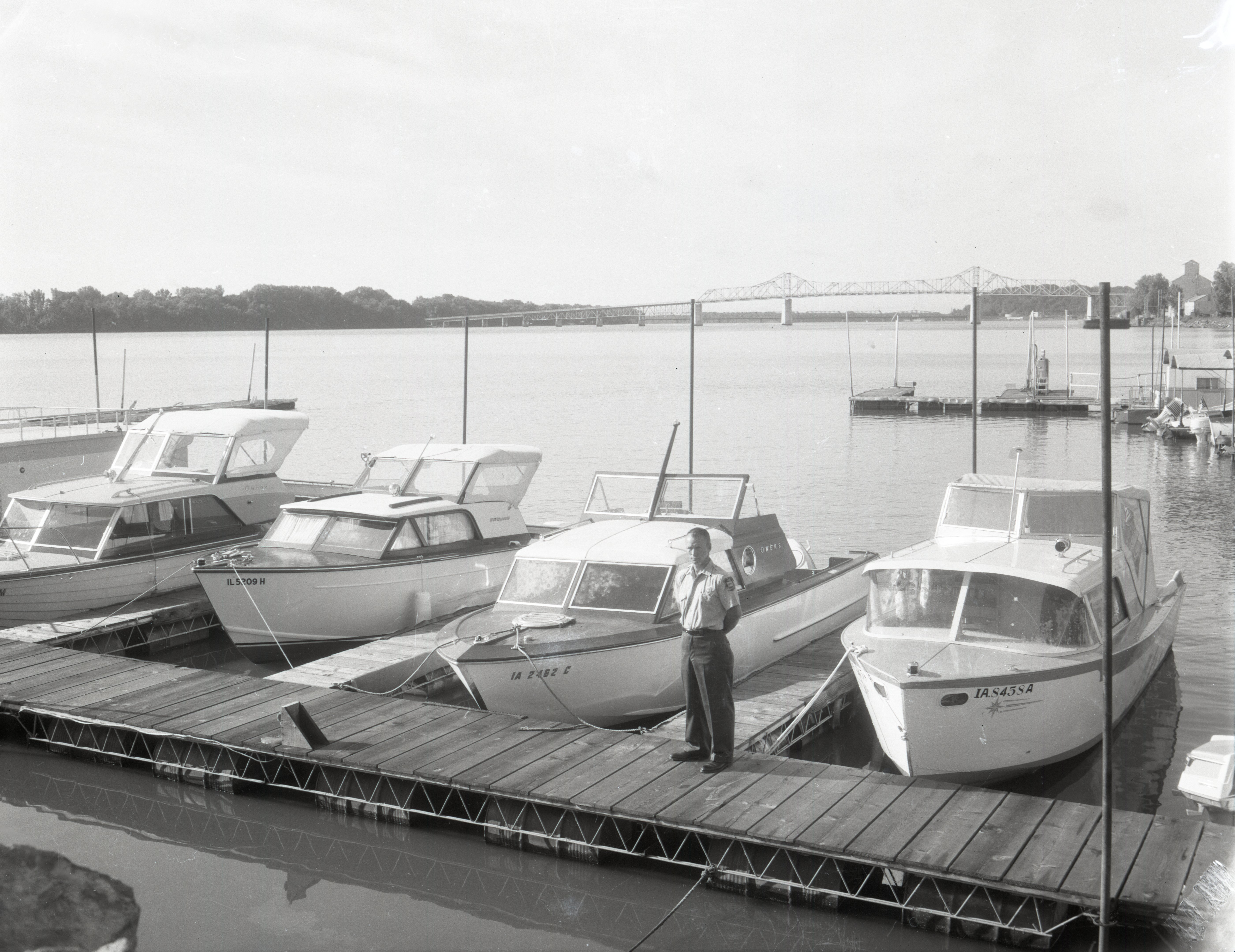 Man stands on dock by boats