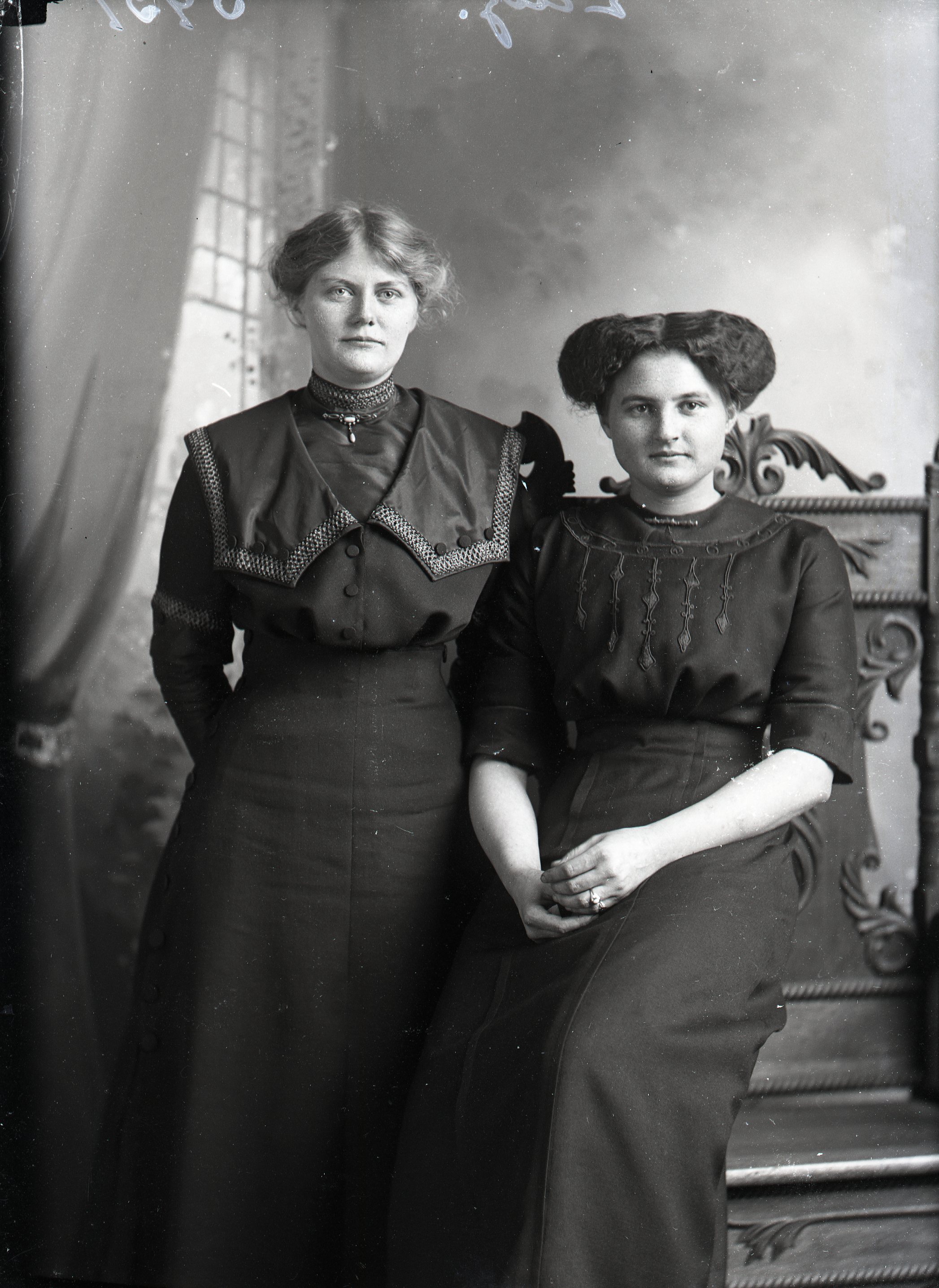 Two women by chair