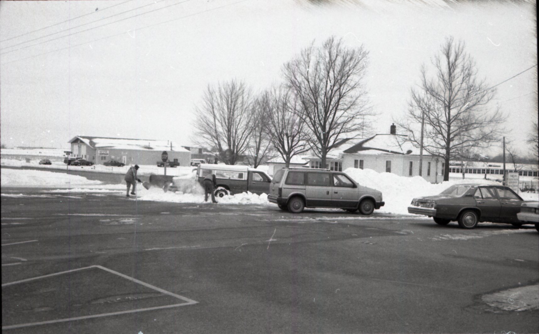 1970's Shoveling snow in parking lot