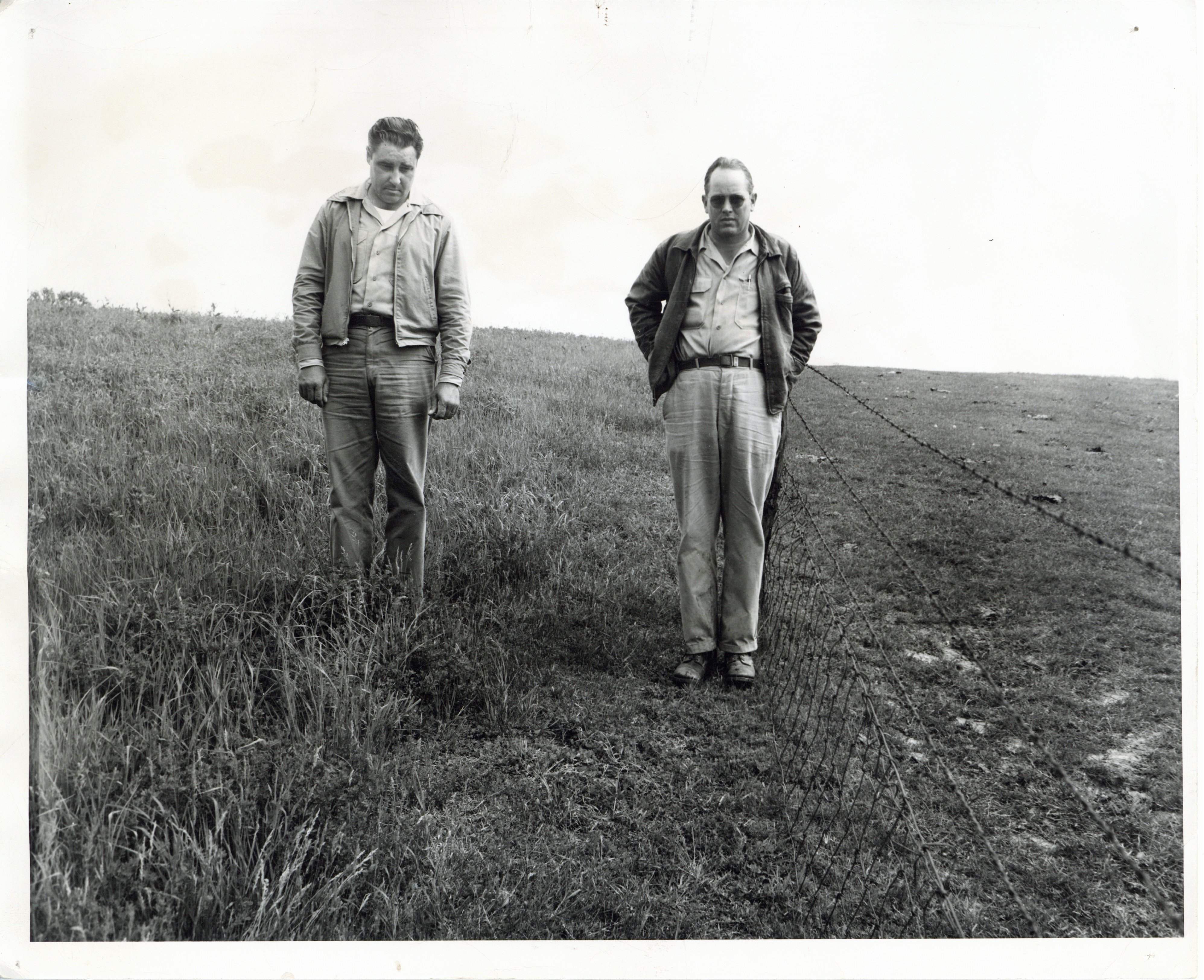 Unidentified men walking in a field