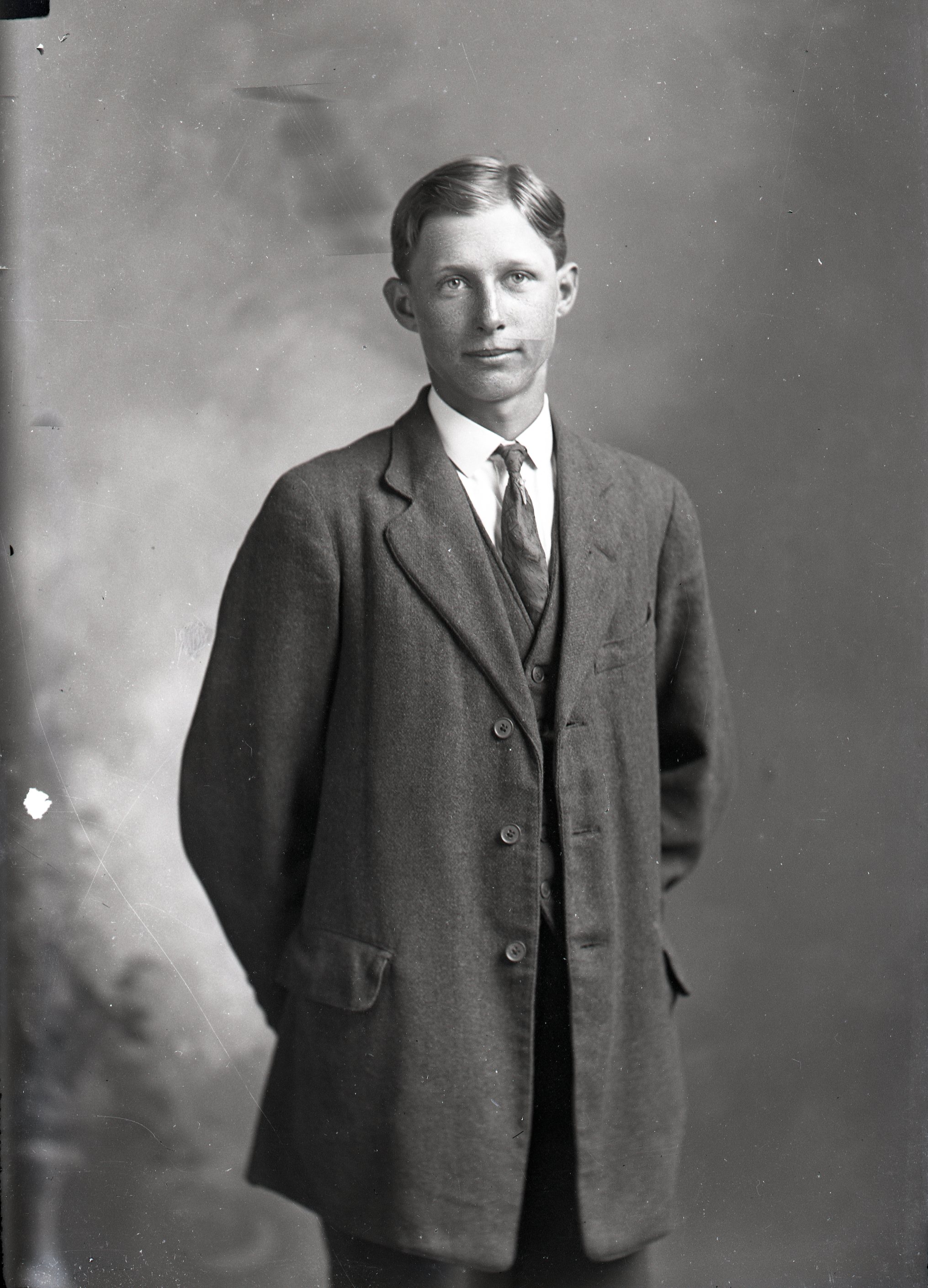 Man in coat, standing