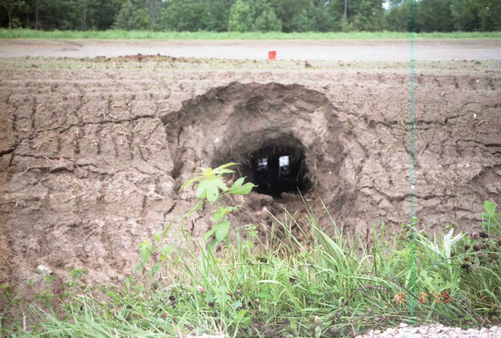 Hole in dirt wall by road