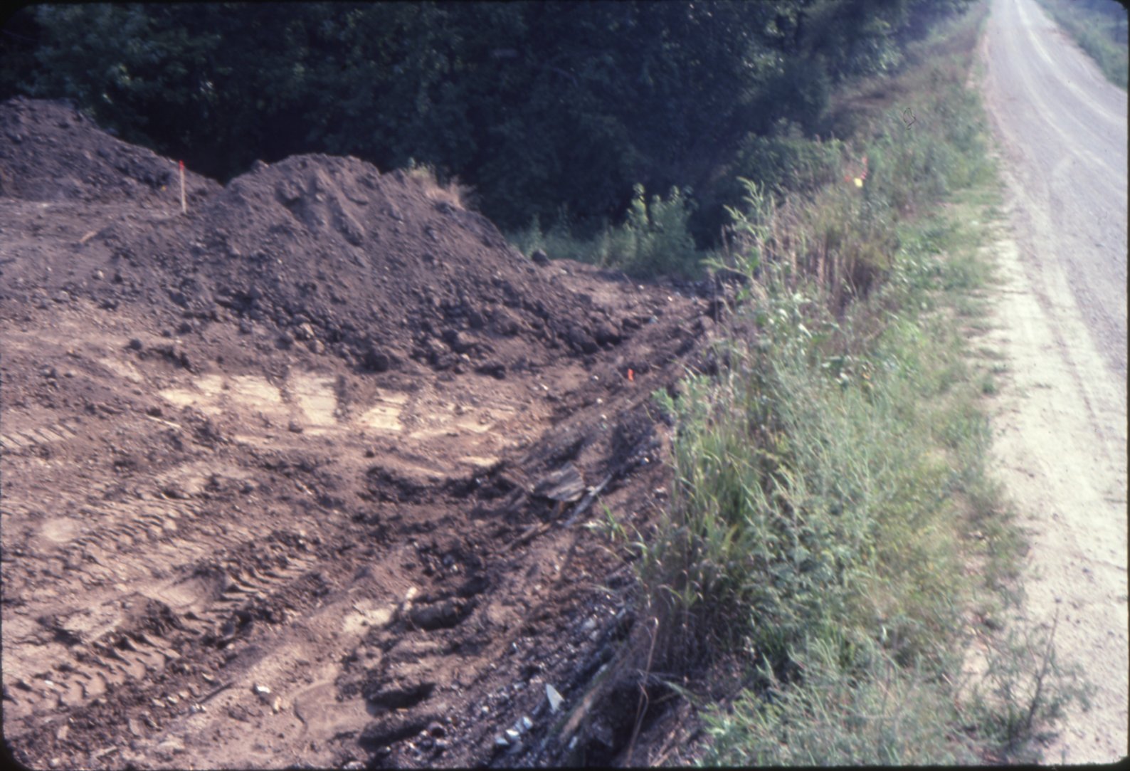 Bulldozed earth near gravel road