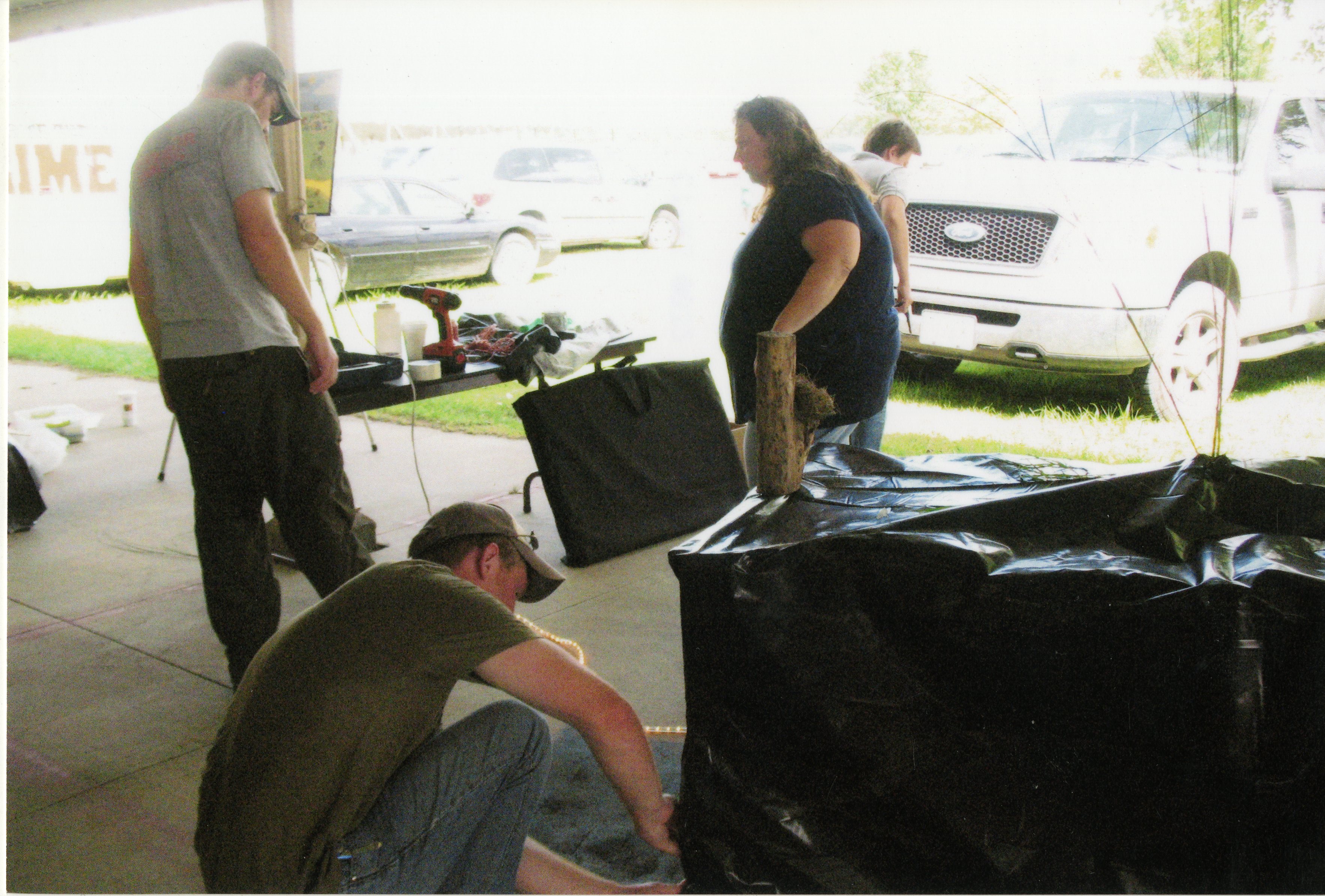 2010  Fair Booth Display table being set up by Caleb Waters, Mark Delperdang, and Jamie Grimes
