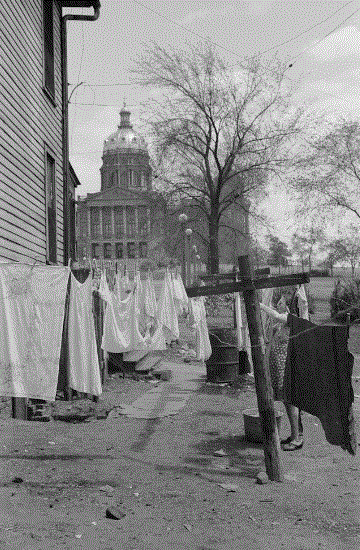 Woman hanging clothes at her home near the statehouse. 
