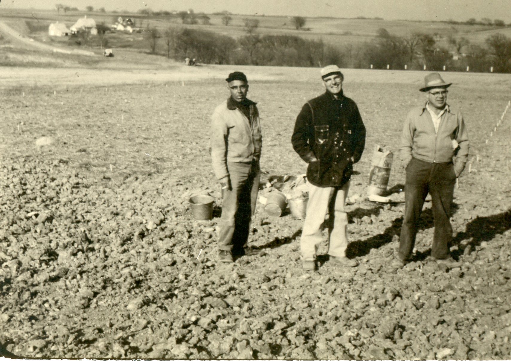 Peterson, Maddy, Moldenhauer standing in uncultivated land, 1959