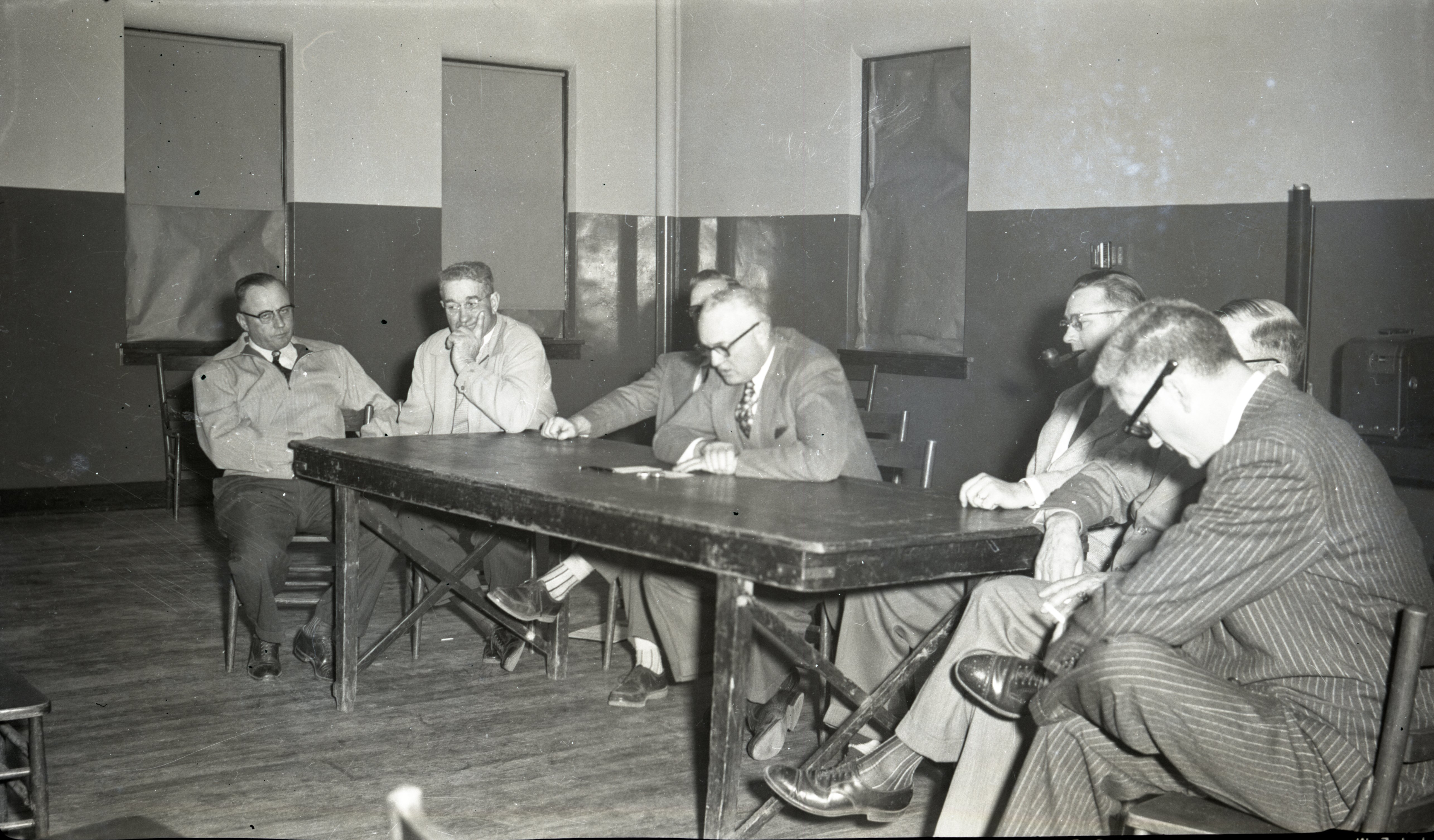 Seven Unidentified  Men Meet Around Table