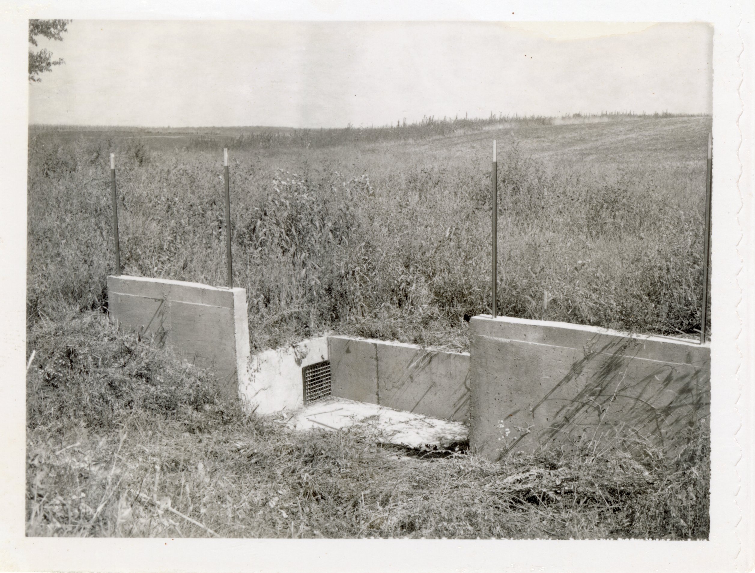 1963 Concrete water drainage culvert in field