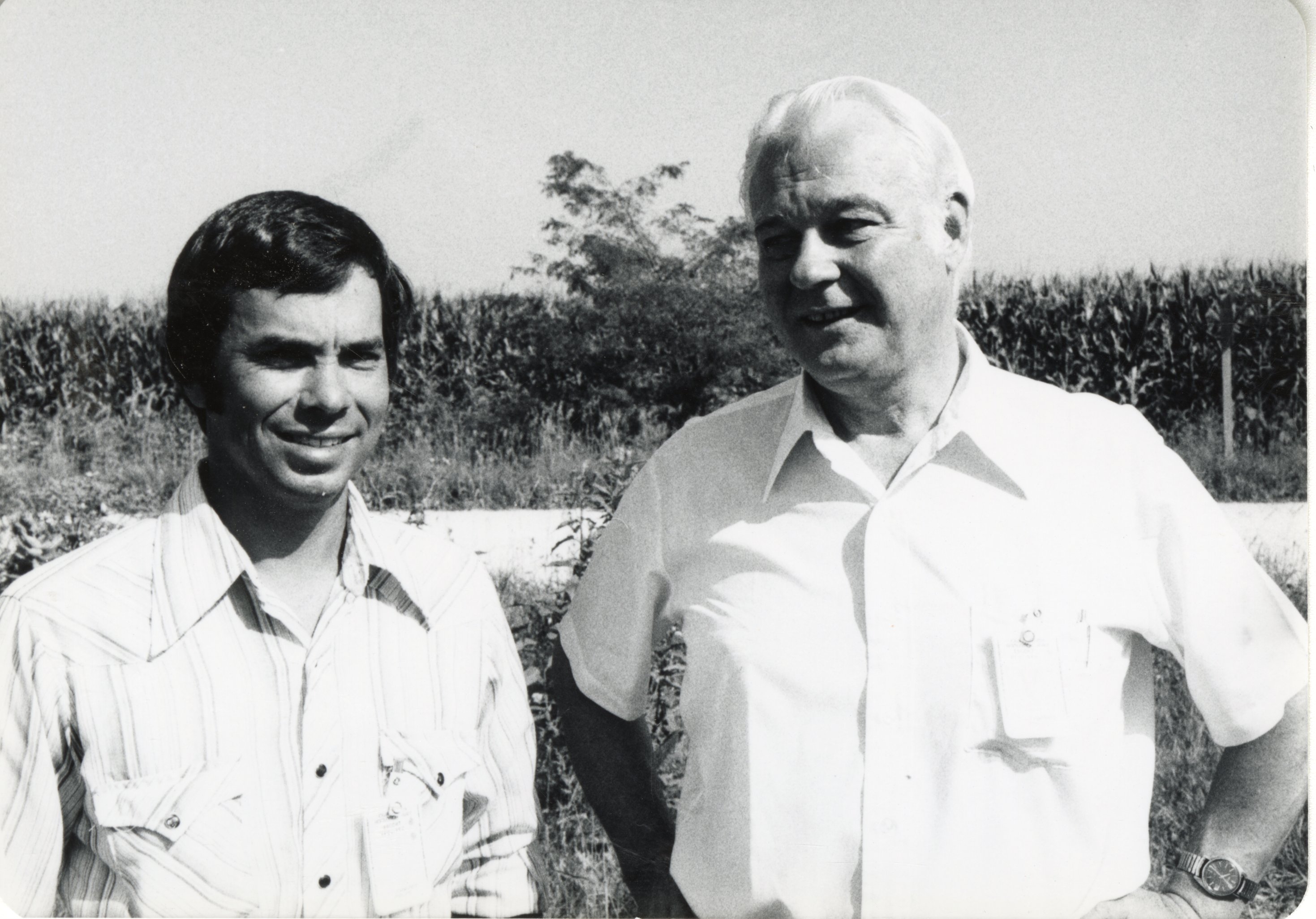 1970s Howard Bright and another unidentified man stand in a field