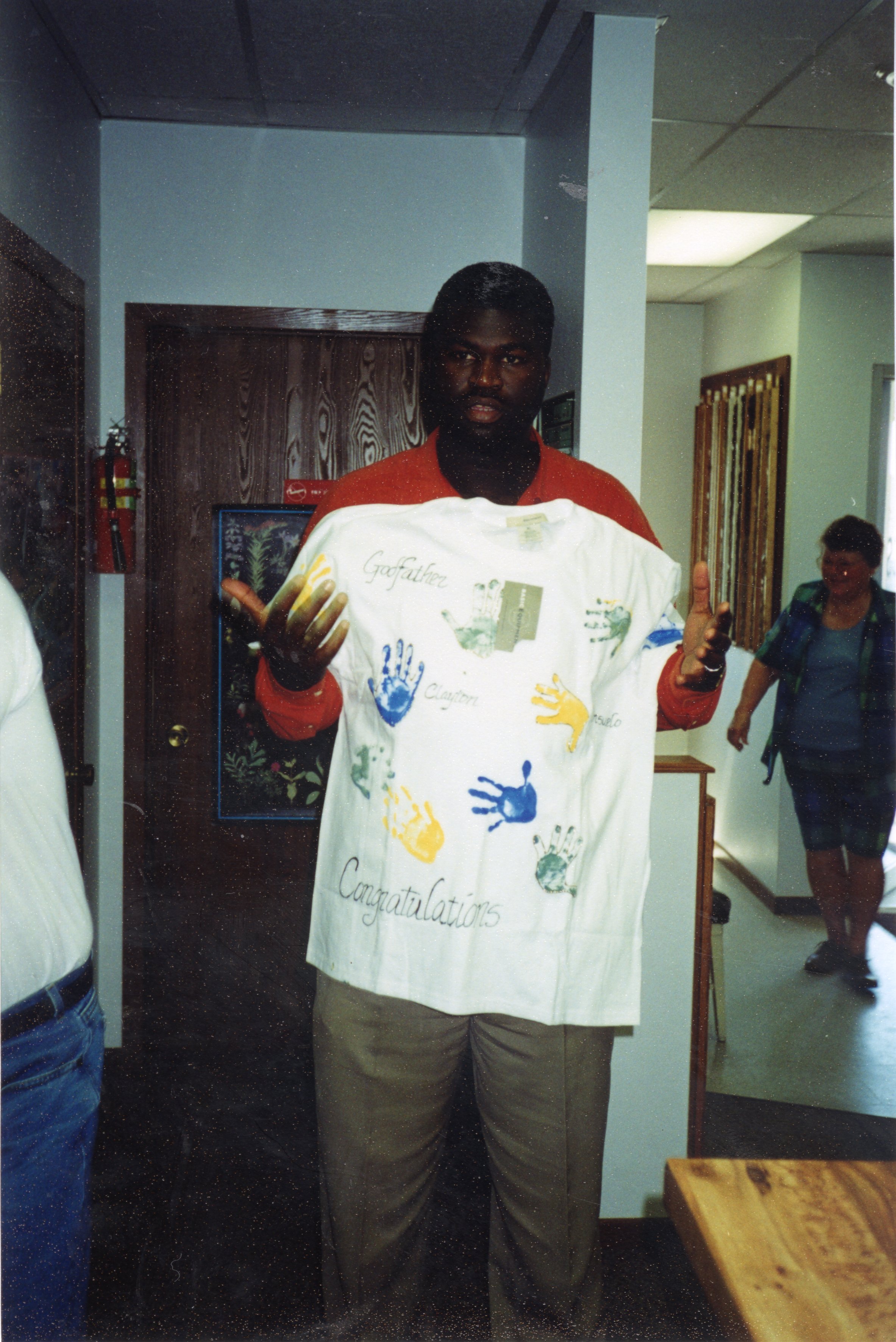 2000  J.B. Martin with his new shirt from his godchildren at the going away party. 