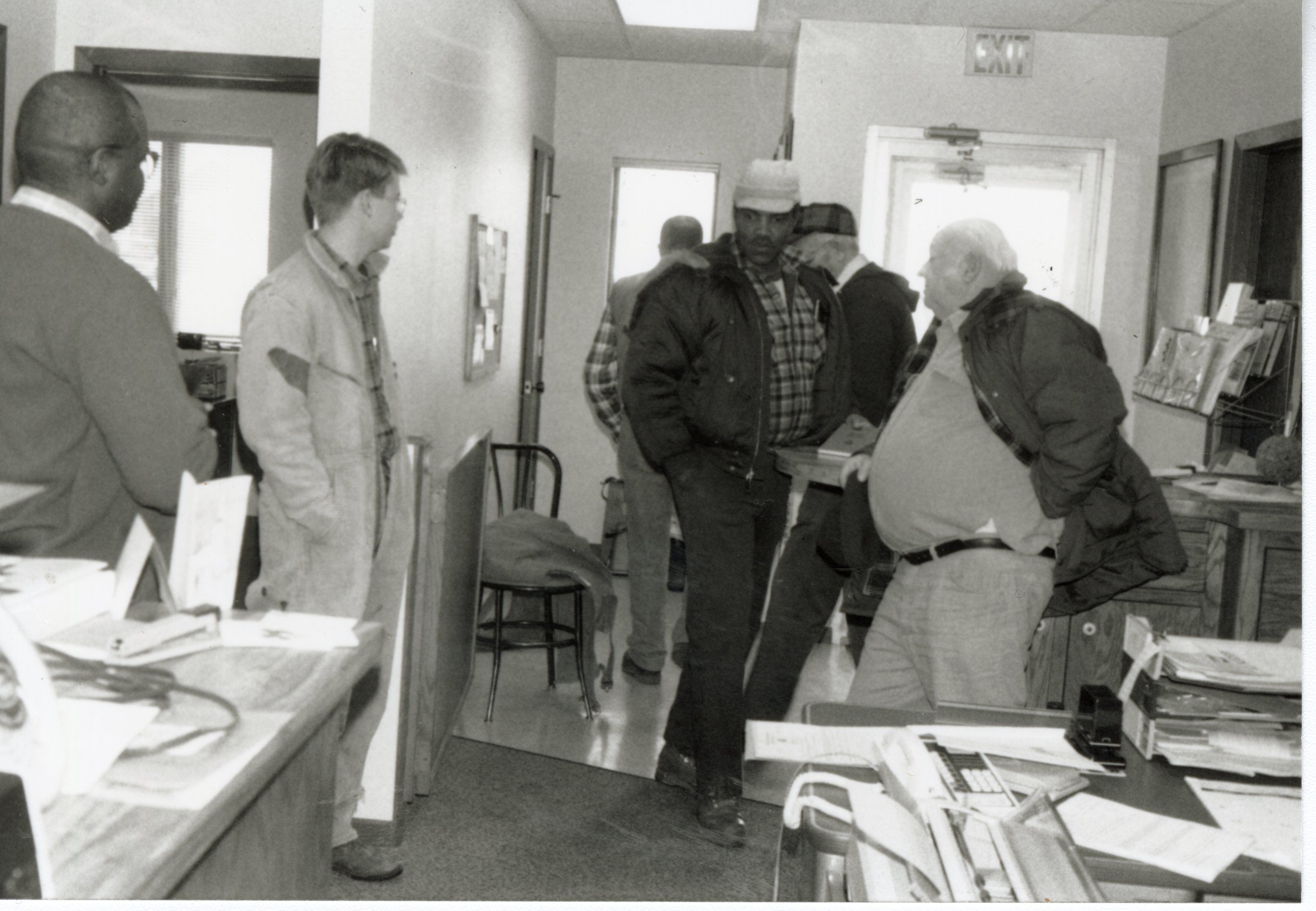 Six Unknown Men Stand in Office