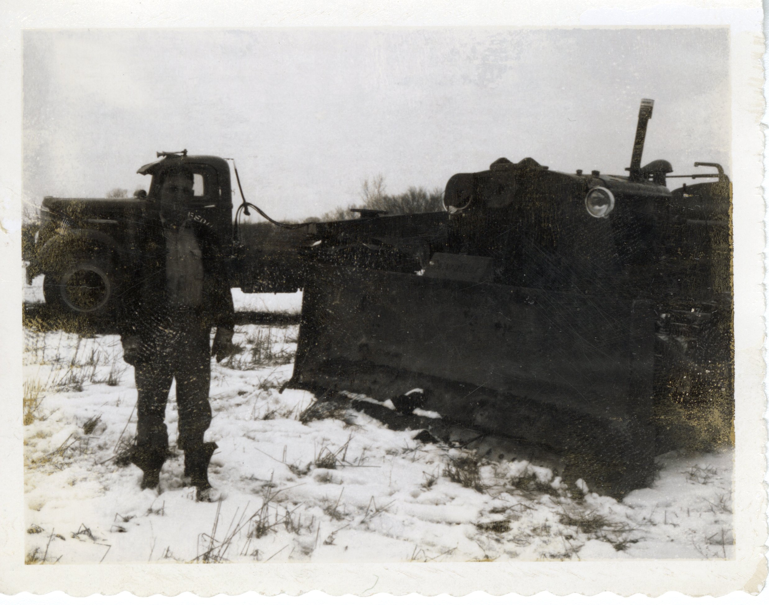 Don Gibson Stands Beside Farm Machinery in Davis County