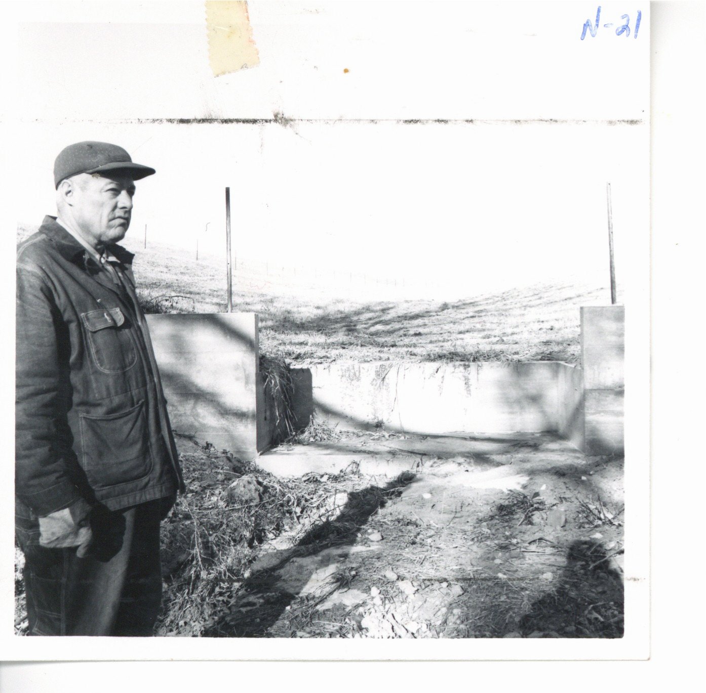 Verne Scheckel with erosion control structure in background