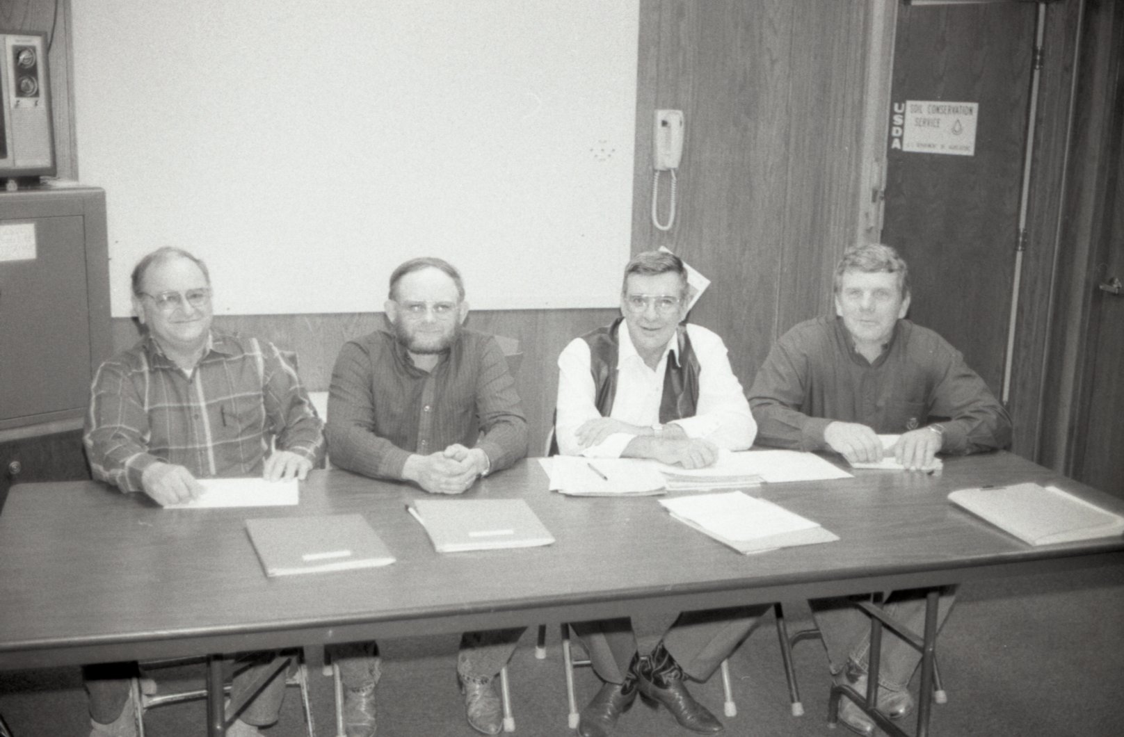 Four Men at a Meeting