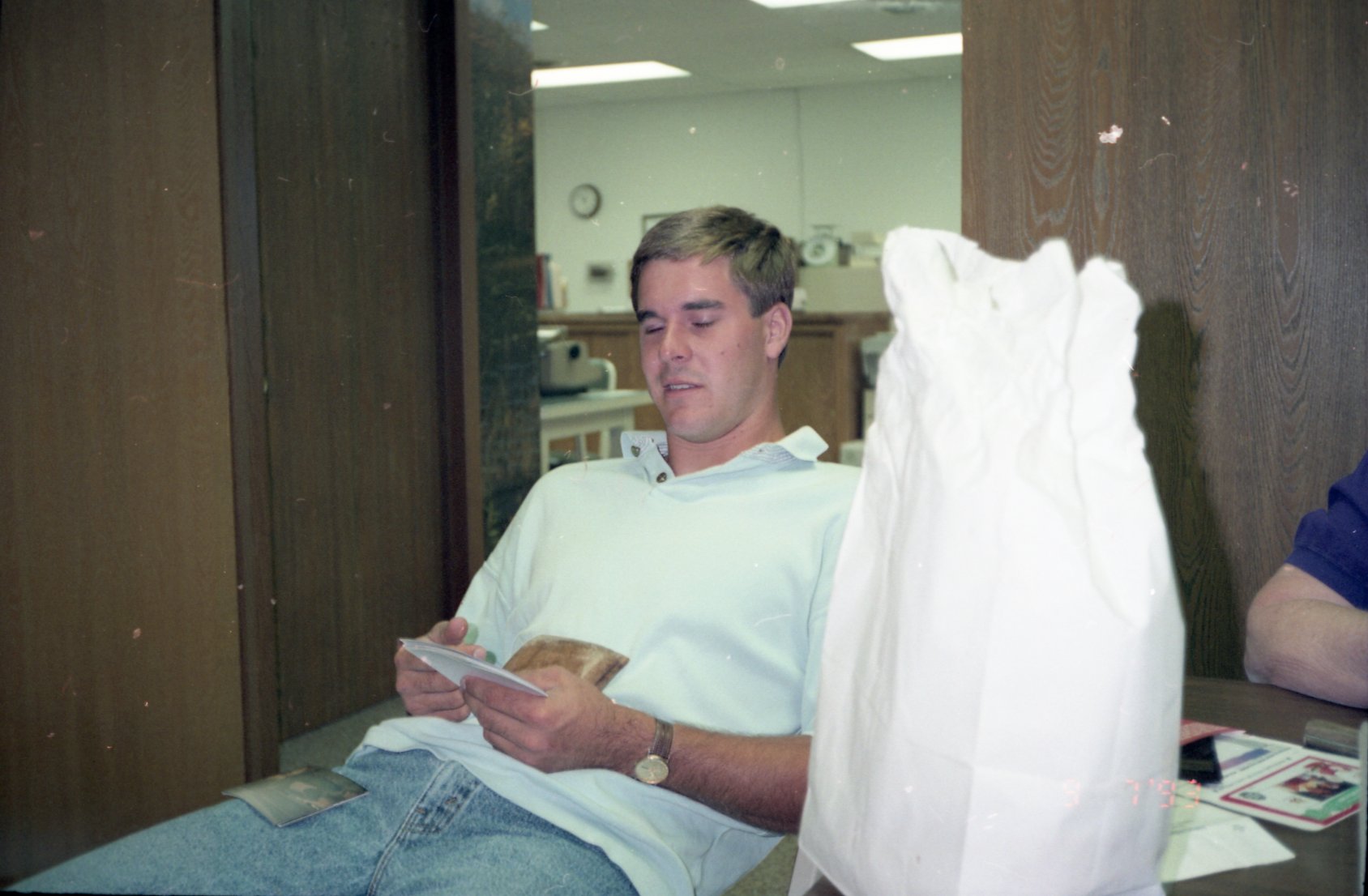 Man with eyes closed sits in office