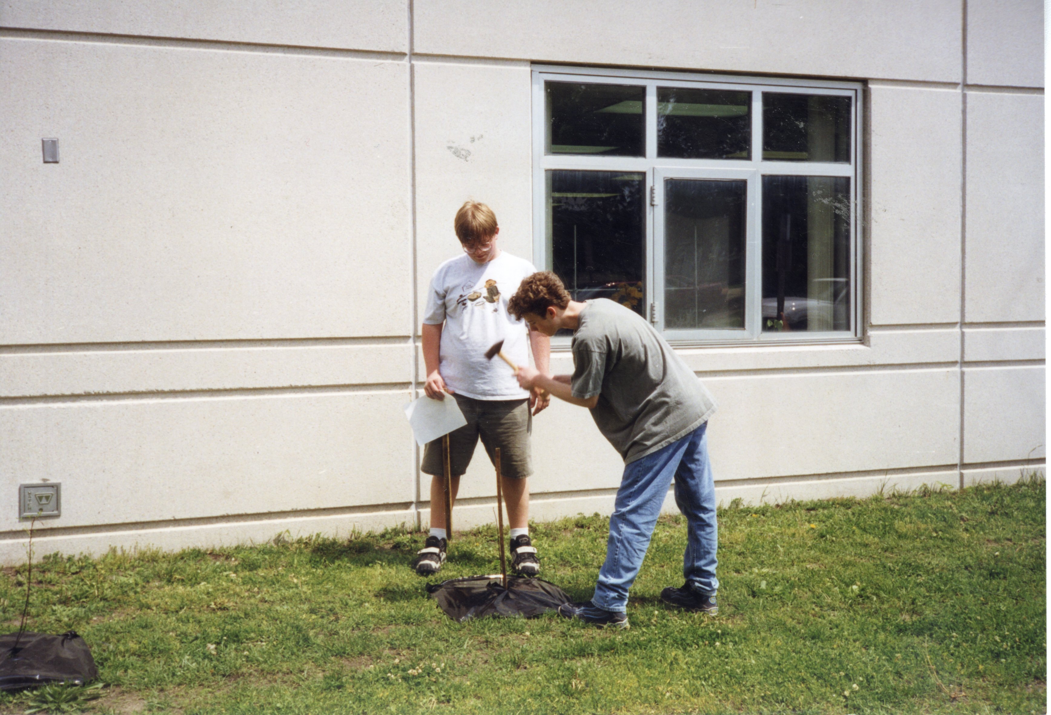 1999 John Allen and Dennis Carter drive stakes into the ground for tree planting