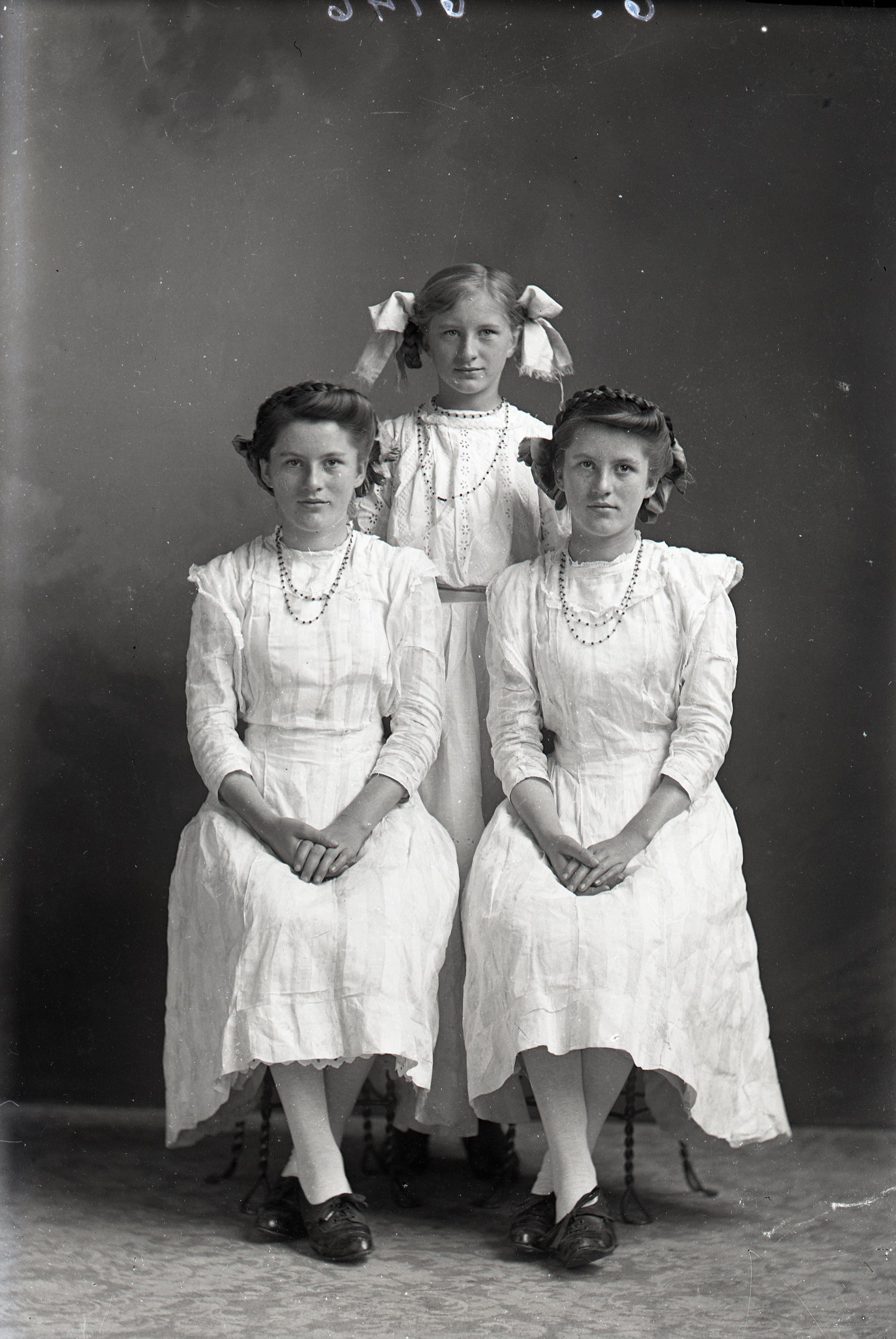 Three girls in white dresses
