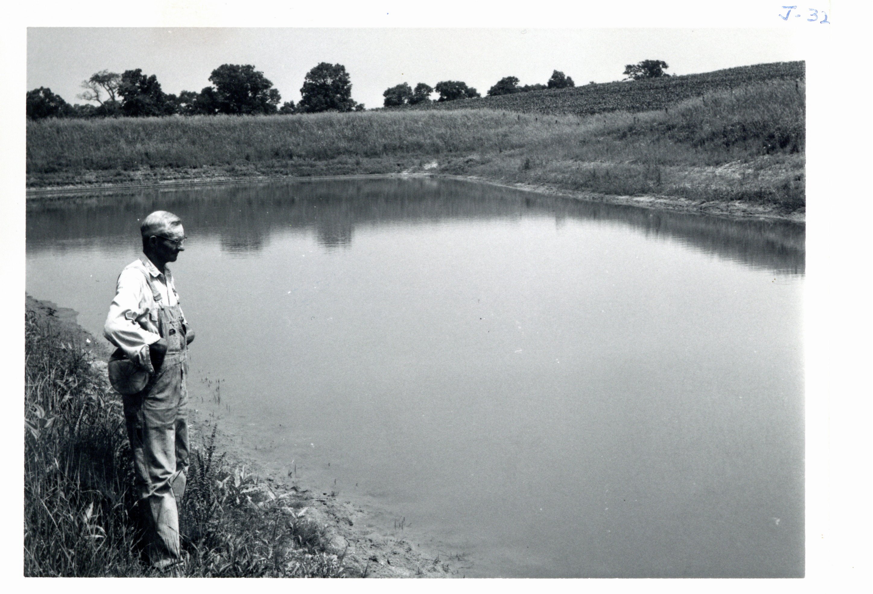 Frank Weiland viewing his pond, 1966