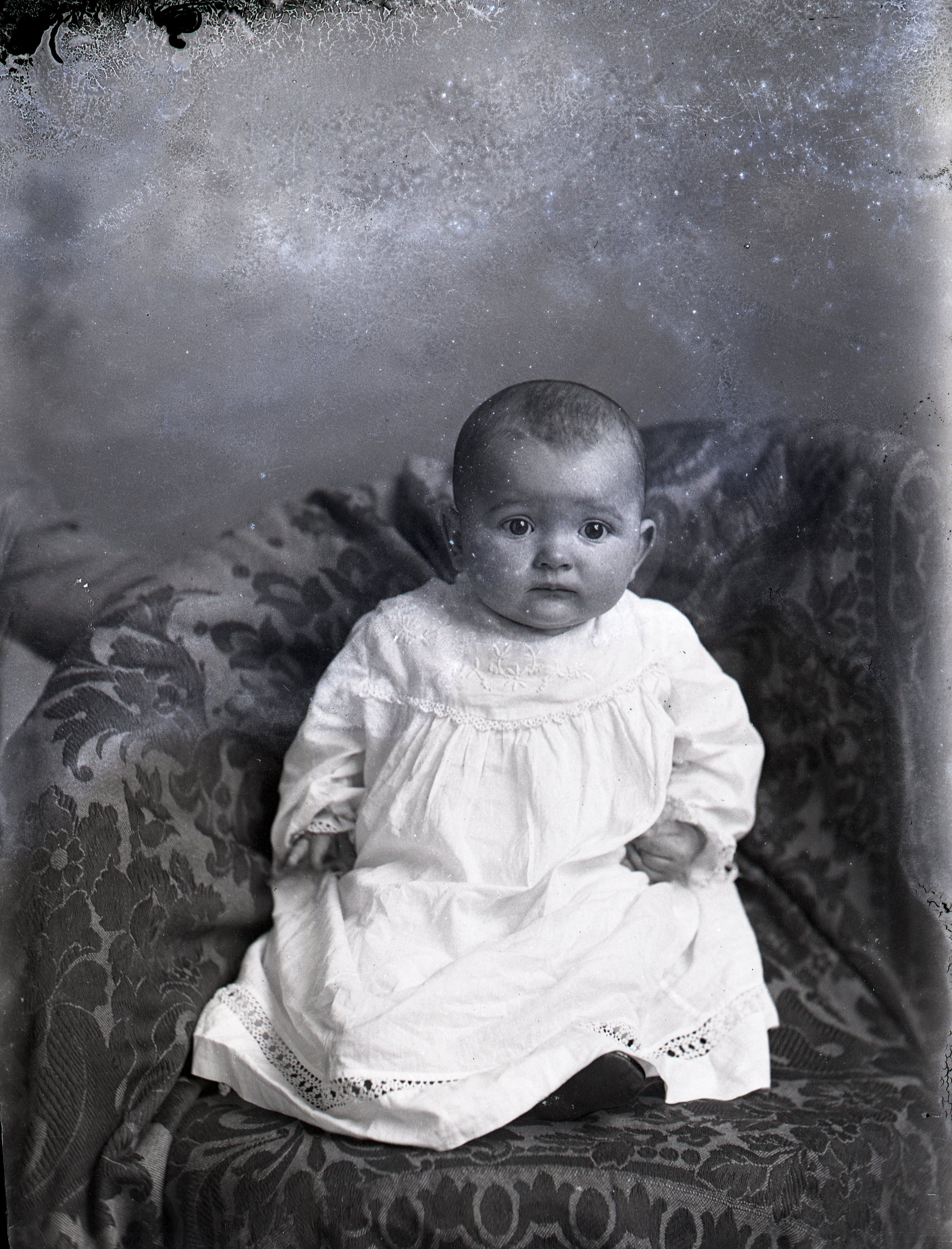 Infant in white dress