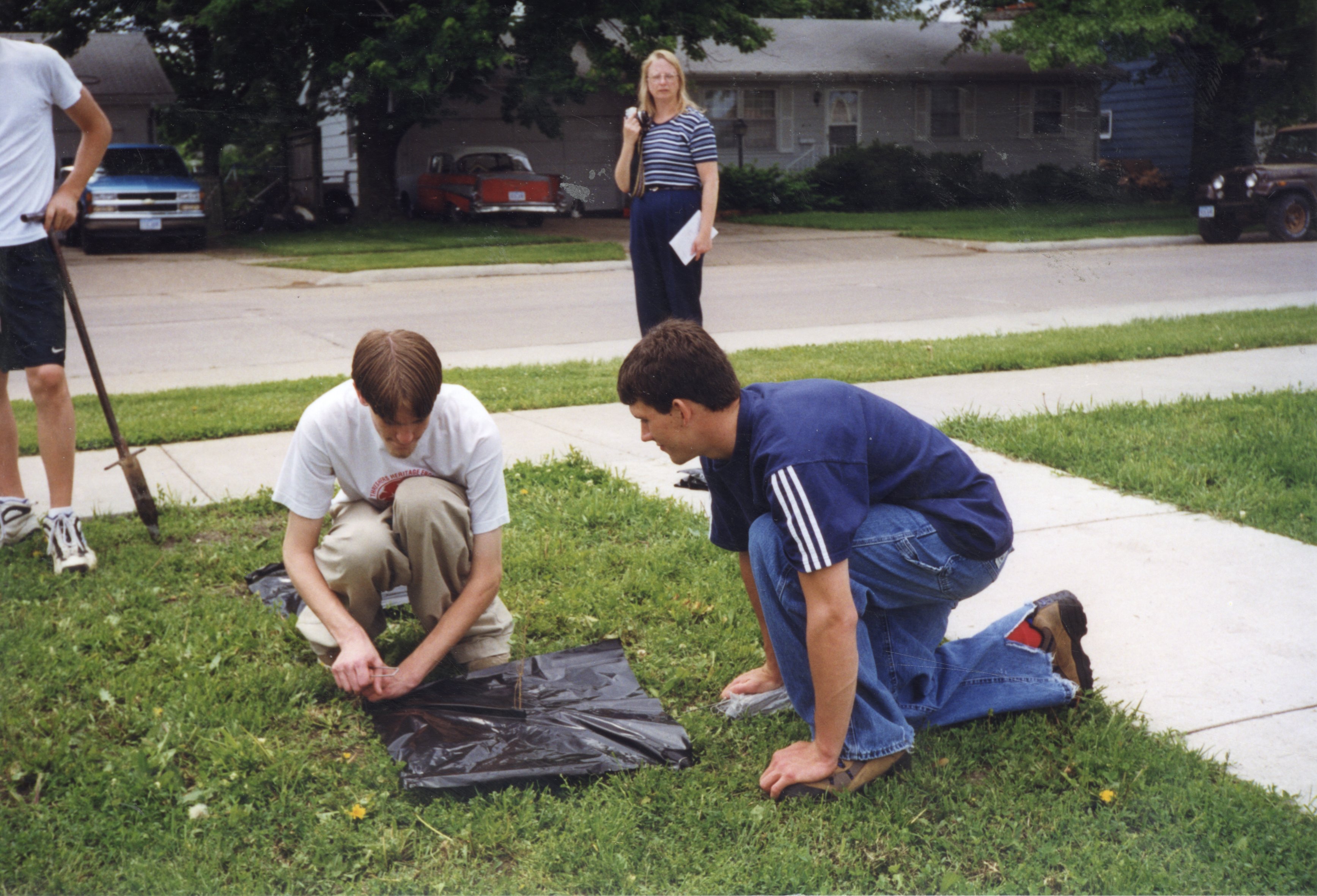 1999 Students anchor the plastic on a newly planted tree