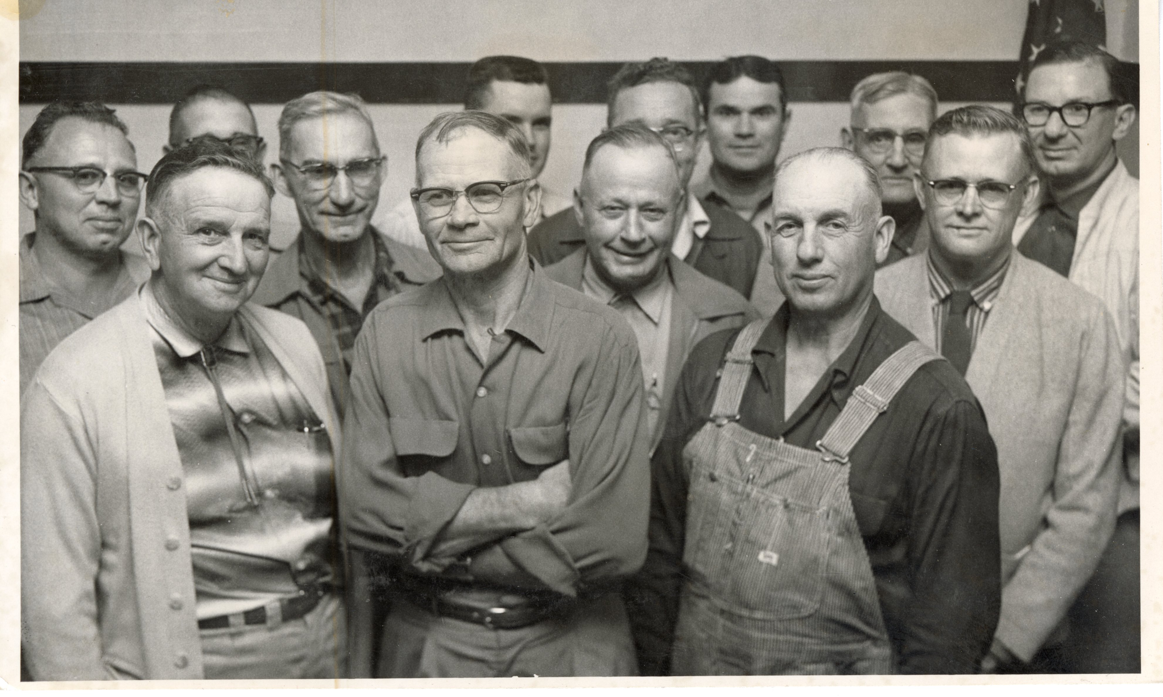 Thirteen Unidentified Smiling Men Pose for Photo