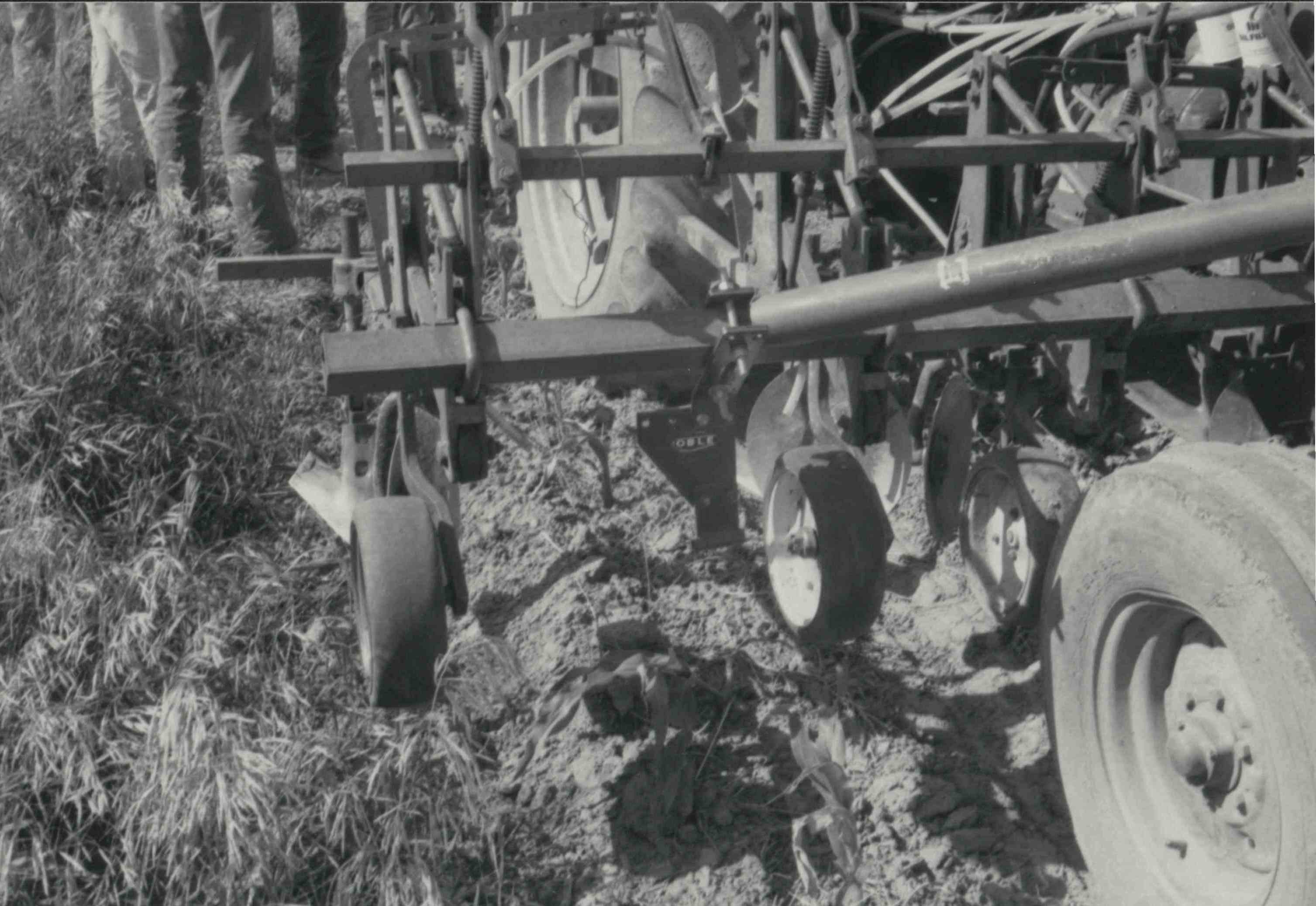 Close-up view of tiller on tractor in field