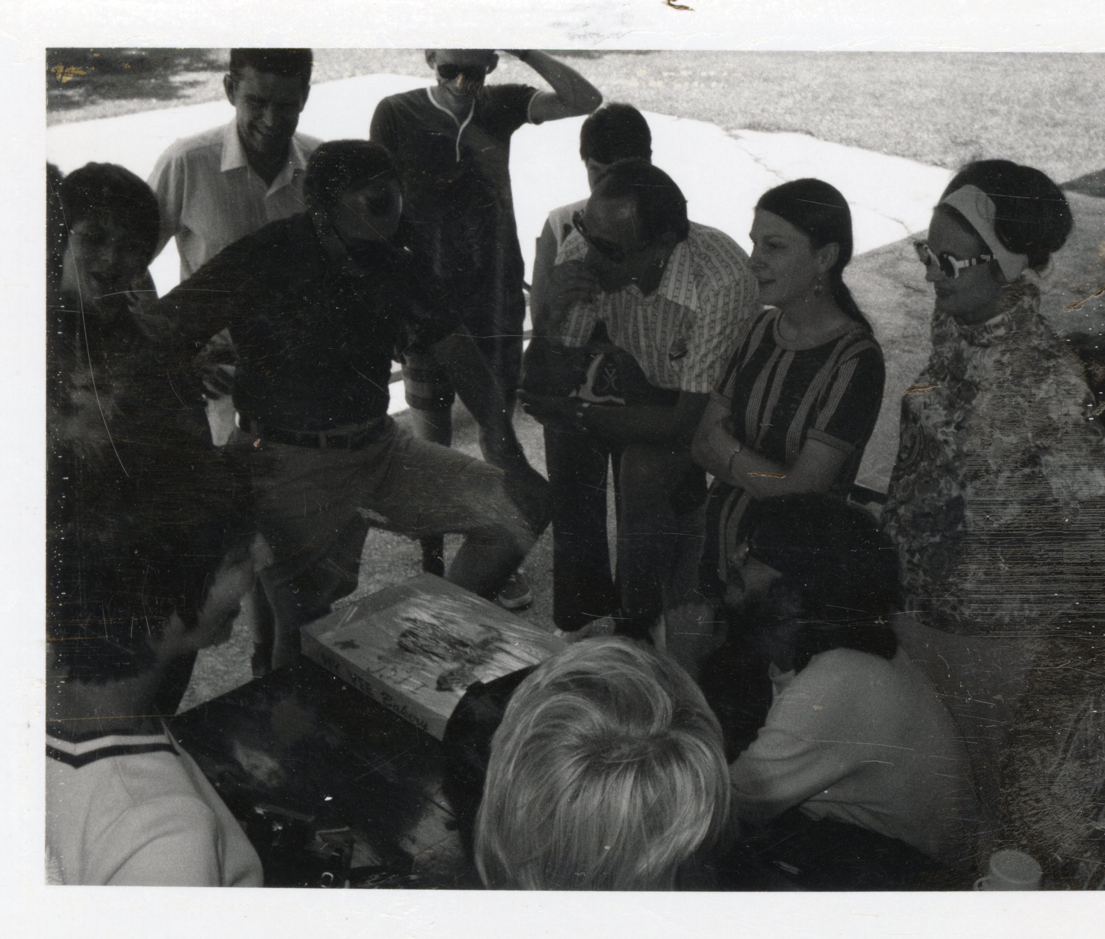 1970s Group looks at rolls in a HyVee Bakery box