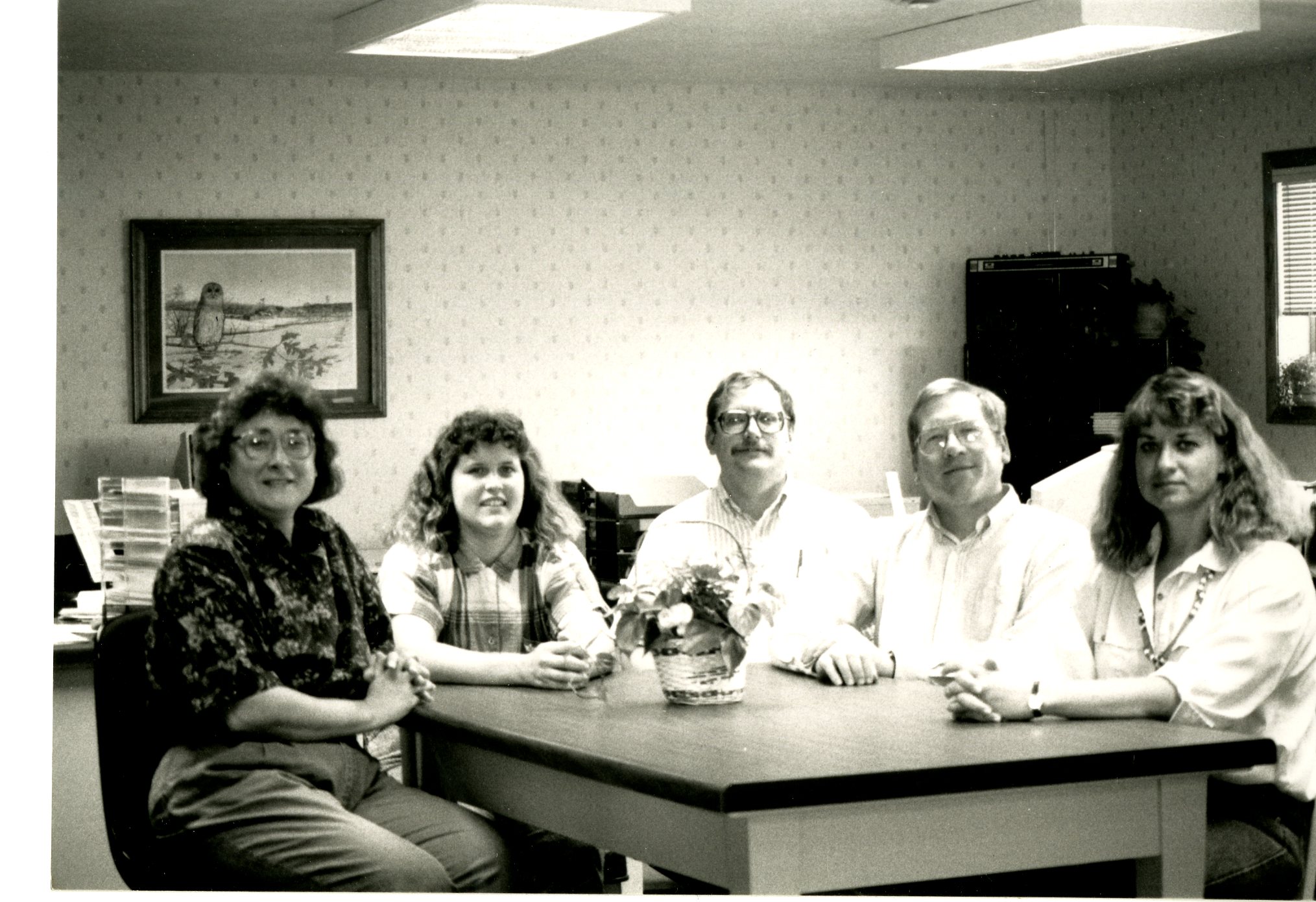 Five People Sitting Around Office Table