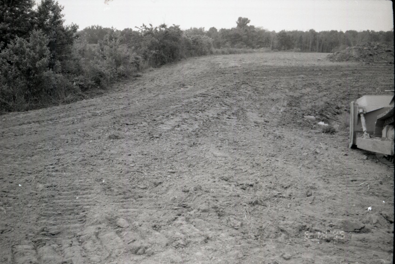 Dirt moved beside trees in field