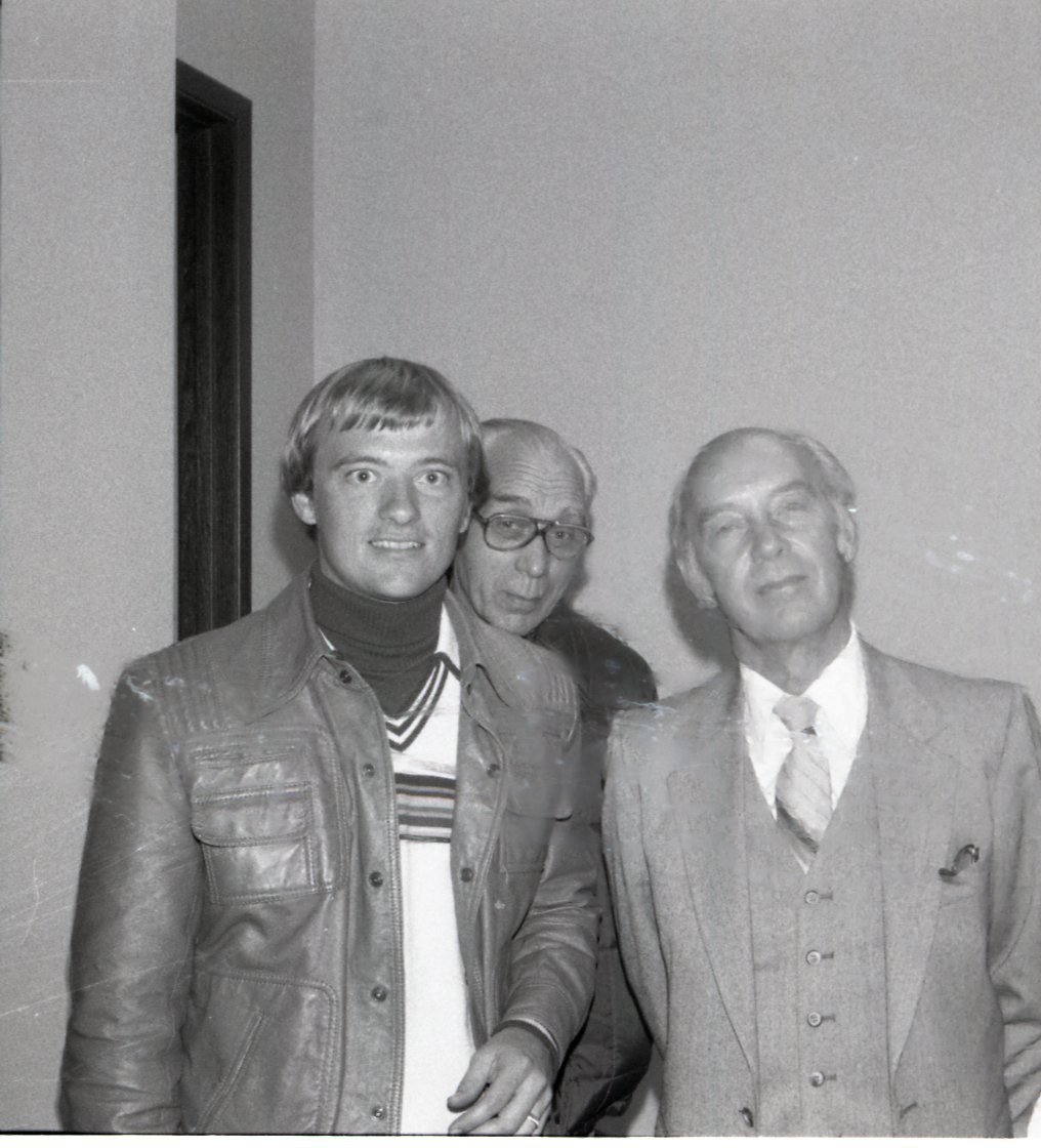 Three men pose for photo