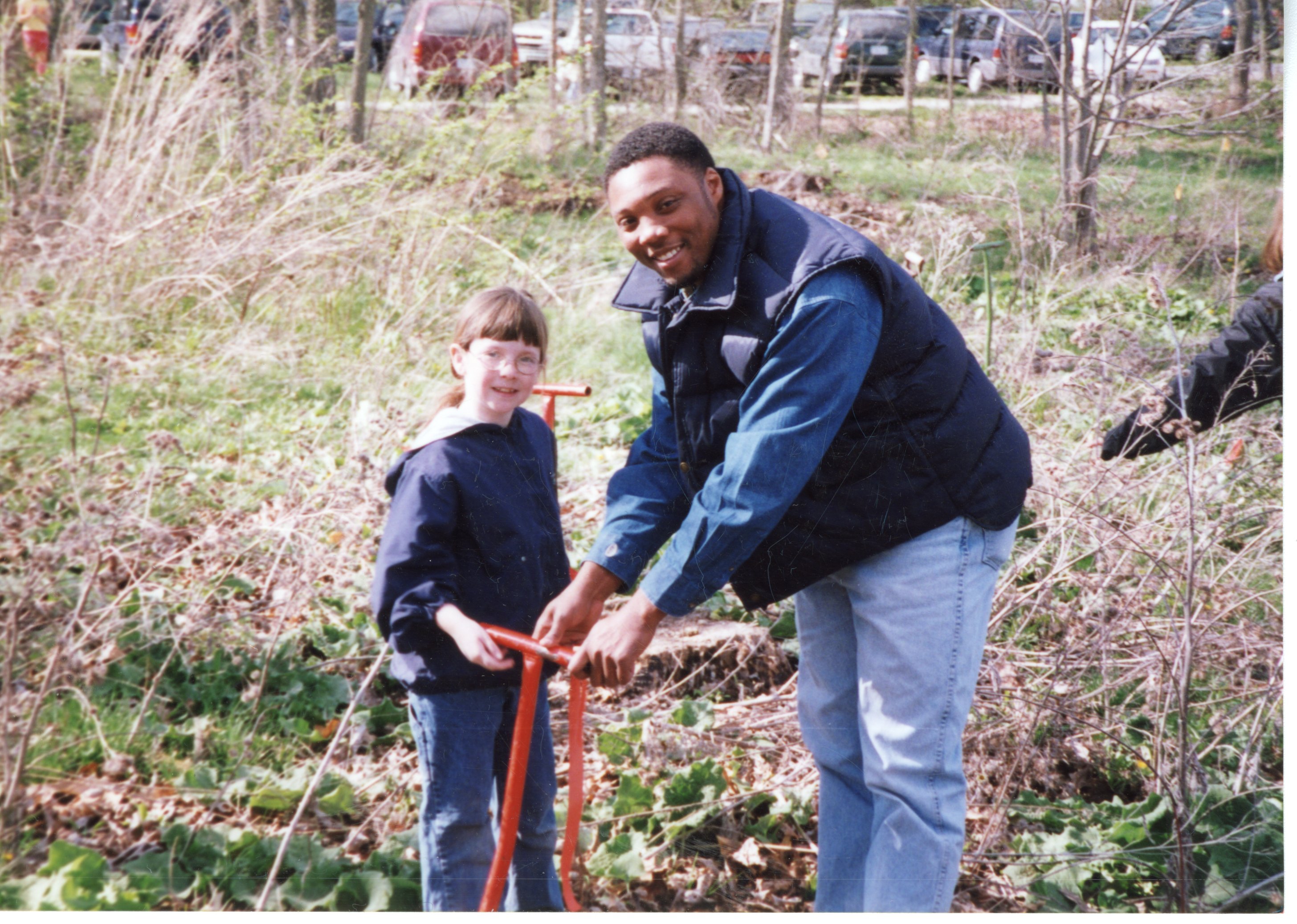 2002  Terrence Rudolph helps girl scout plant a tree
