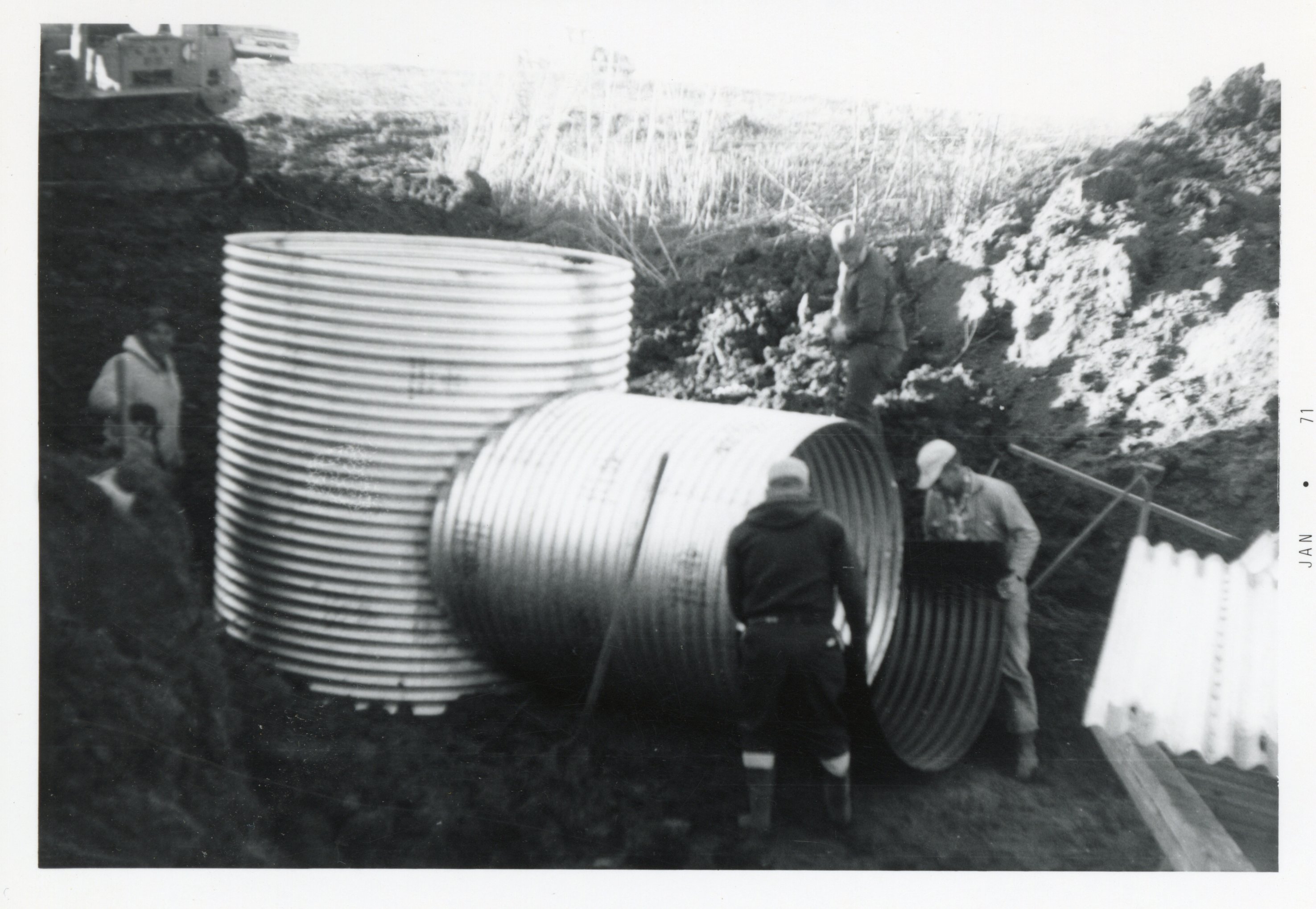 Four Men Install Underground Pipes