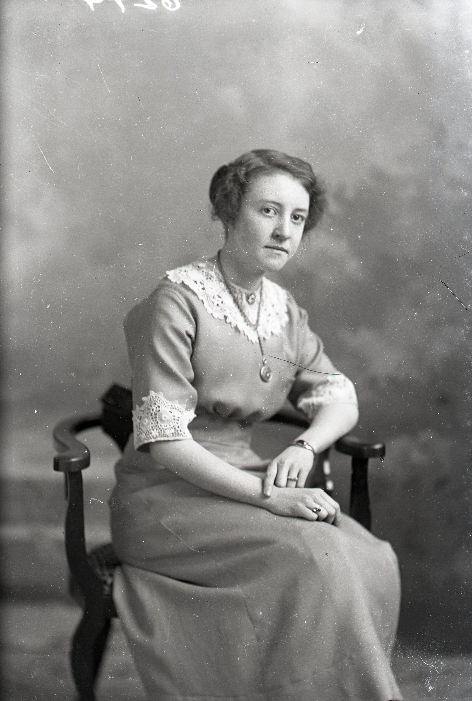Woman seated with necklace