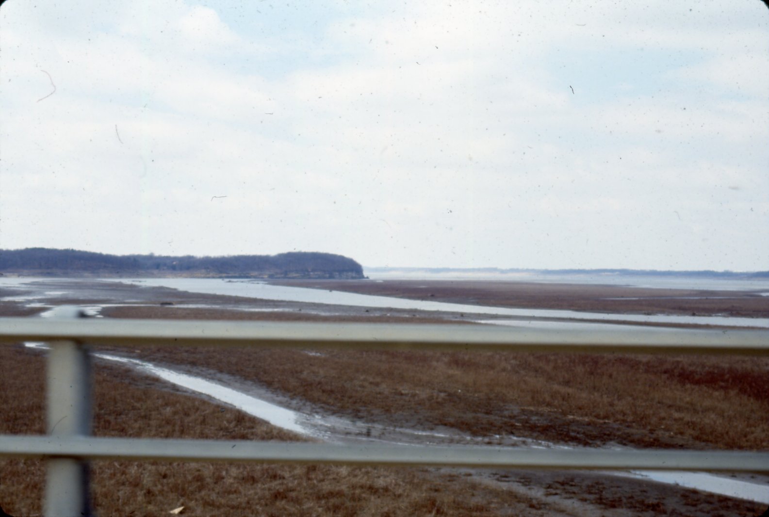 Road bridge overlooking unidentified body of water, 1980s