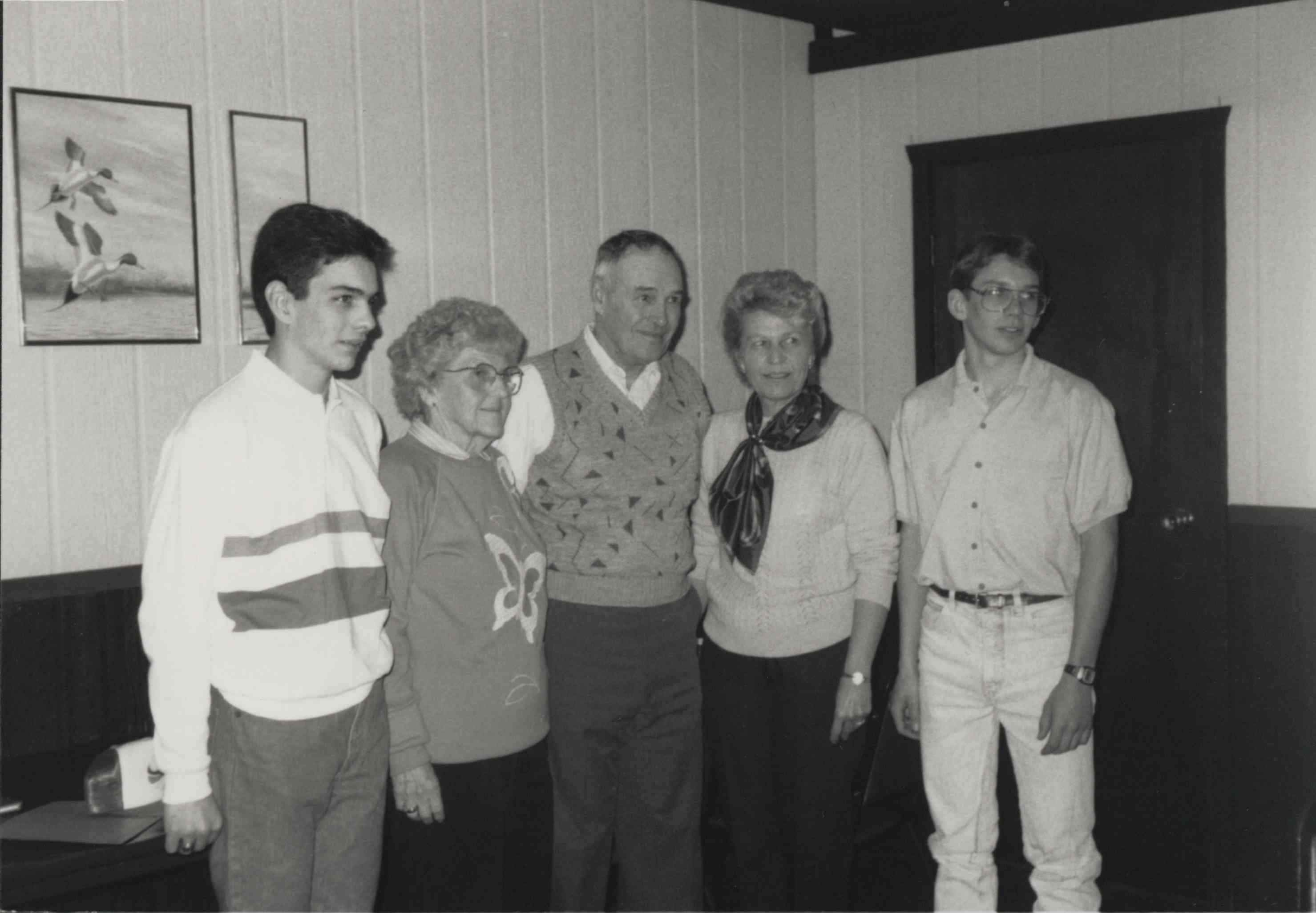 Office Photo with a man, two teenage boys  and Two Women Standing