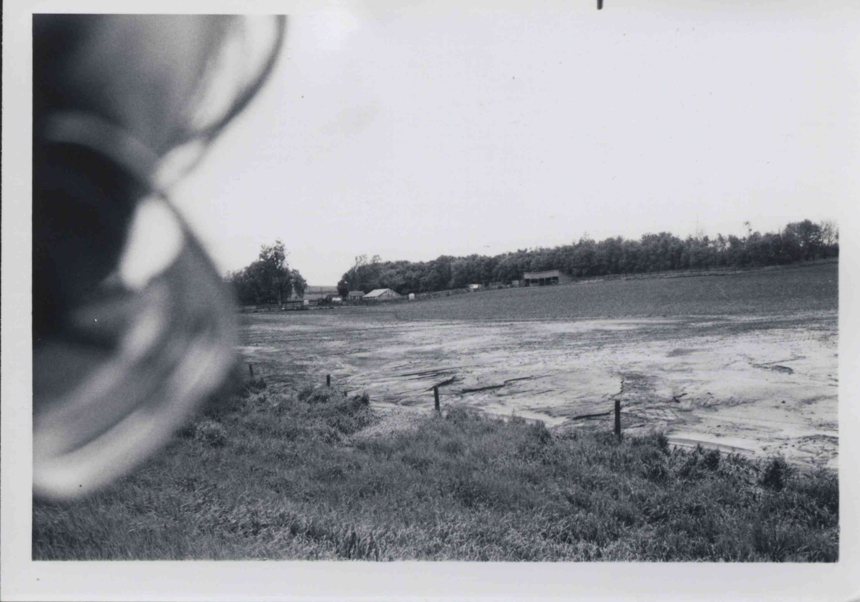 Farm and crop land with a fence that separates the crop land from grassland