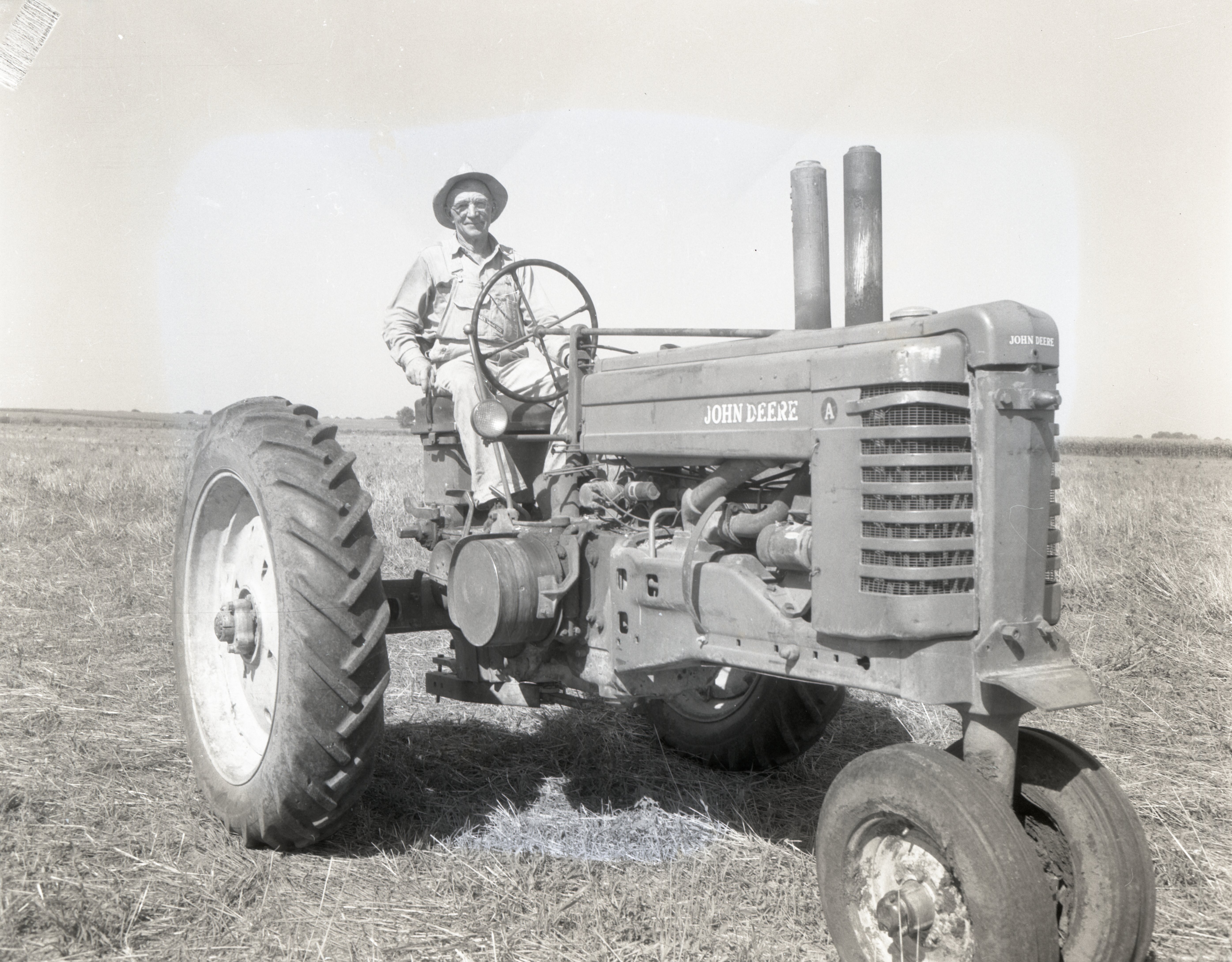 Farmer sits on tractor in field