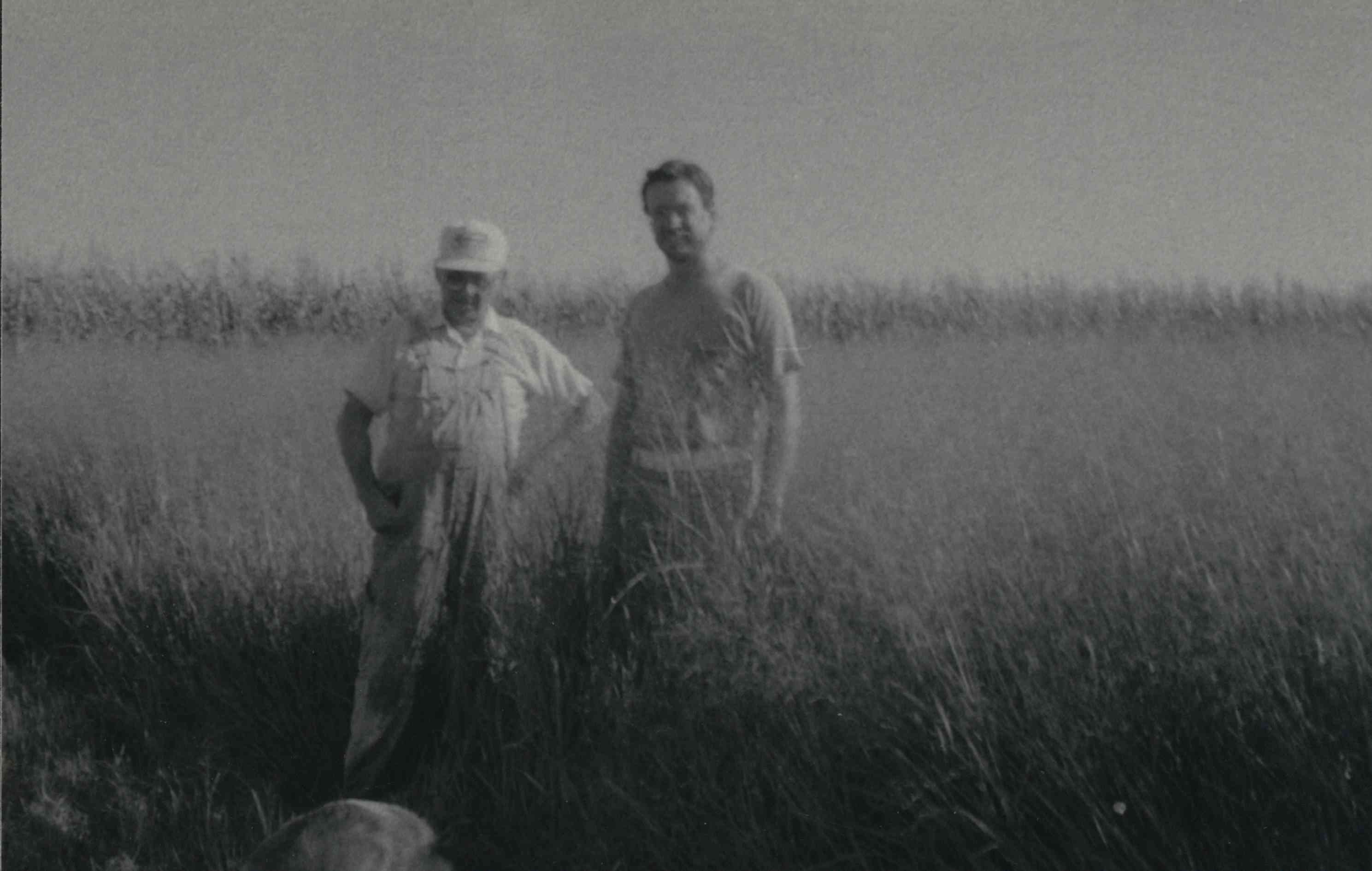 Two views of two unidentified men standing in a grassy field in Plymouth County, Iowa