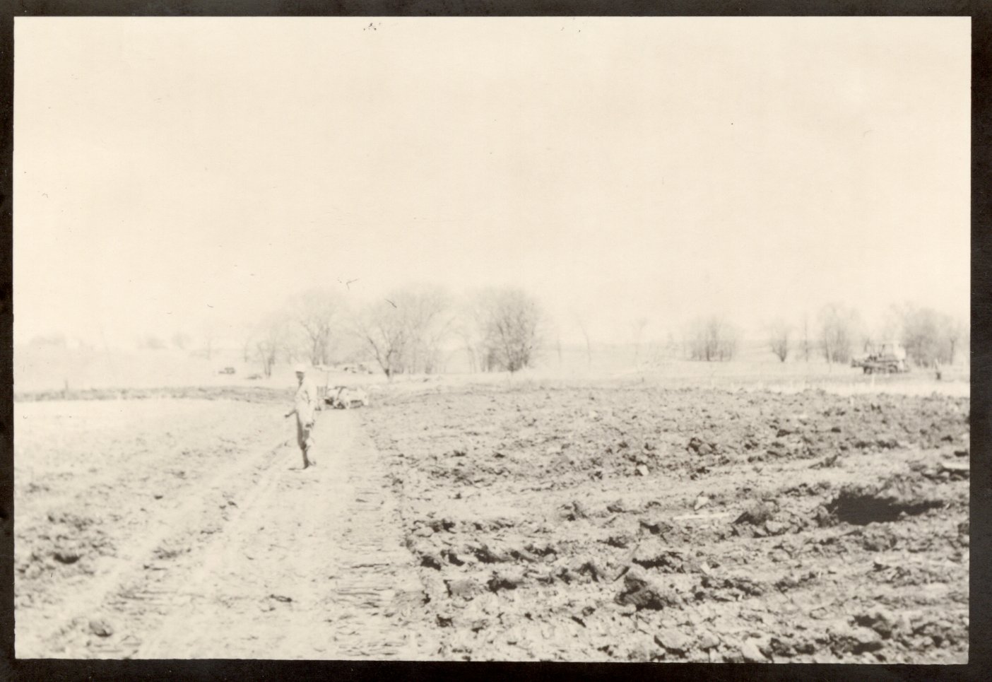 Unidentified Man Stands in Field