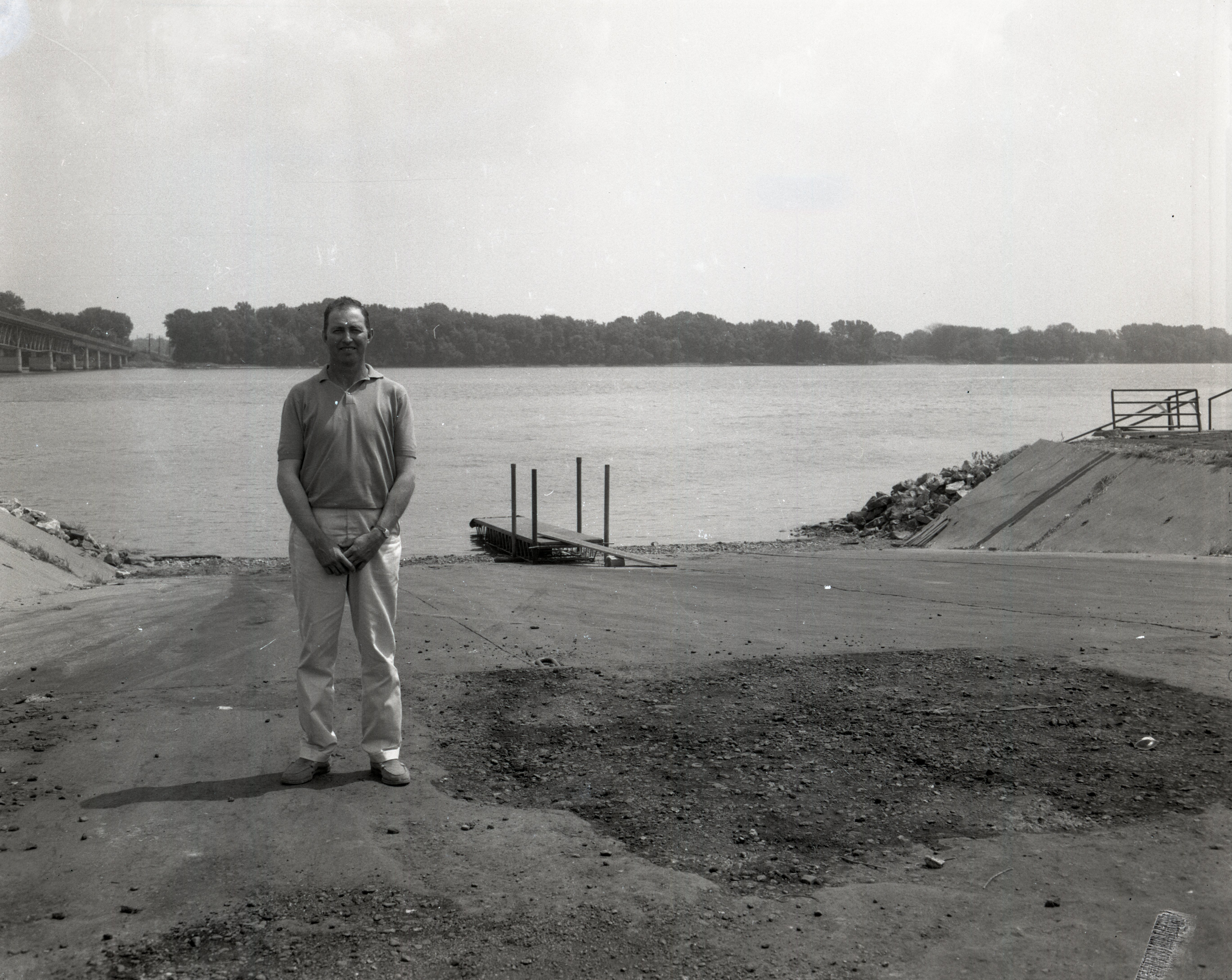 Man stands at edge of river