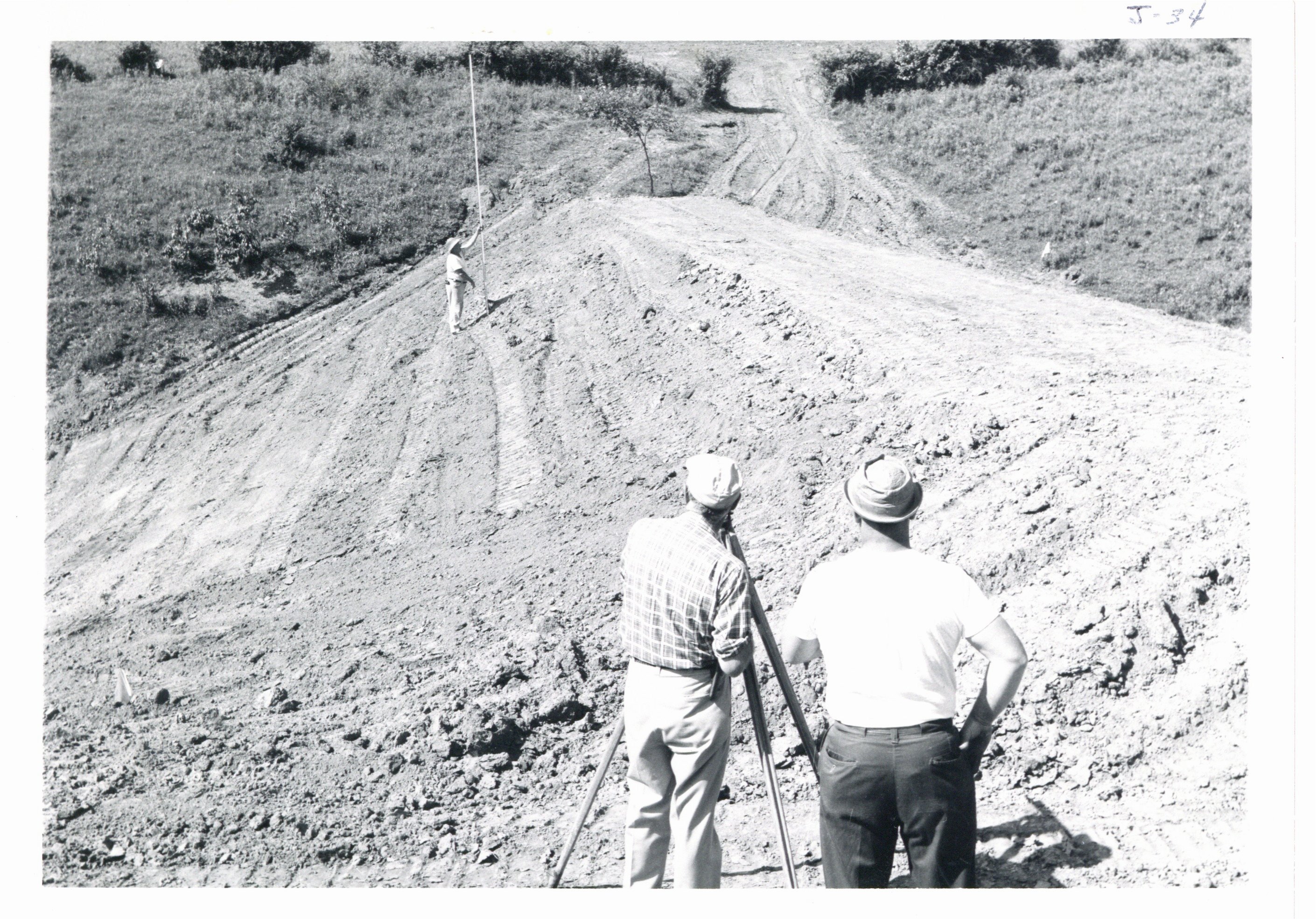 Soil Conservation Services surveying slope of earthen dam, 1967 