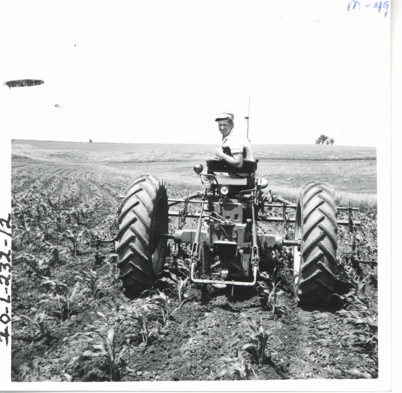 Wayne Meyer cultivating corn field, 1967