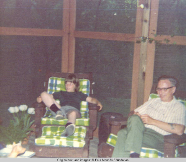 John, Jr. and unknown man sitting in screened in porch