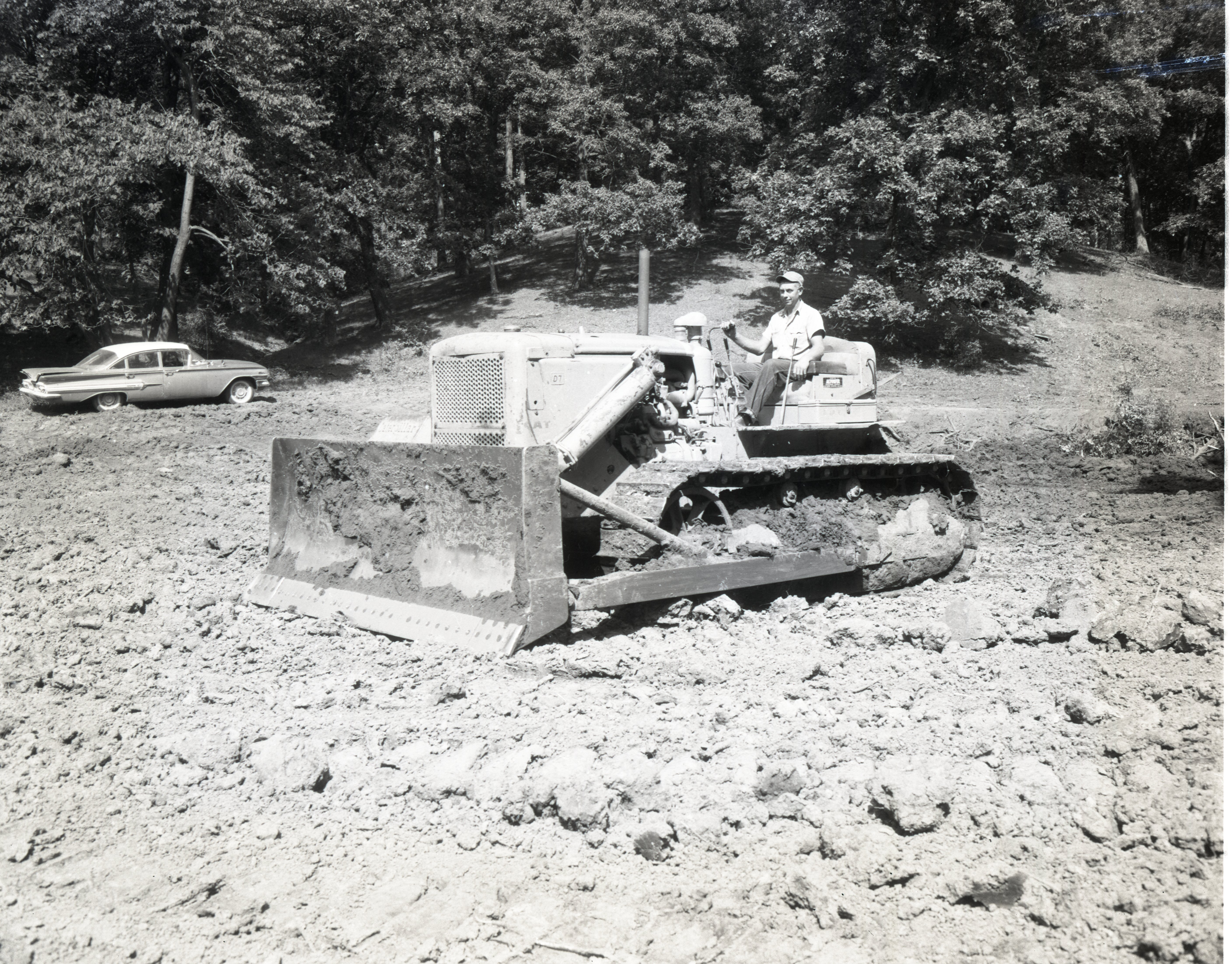 Man sits on bulldozer in field