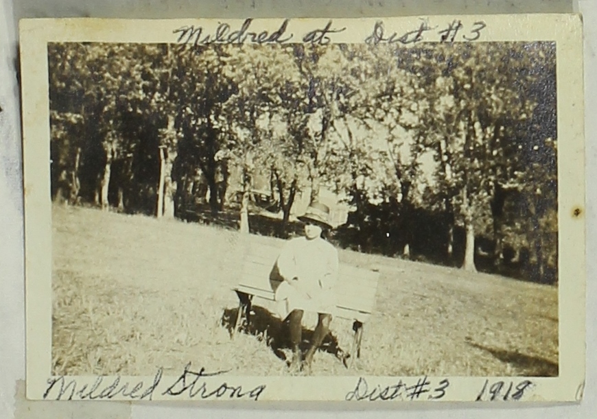 Student Mildred Strong sits on a bench