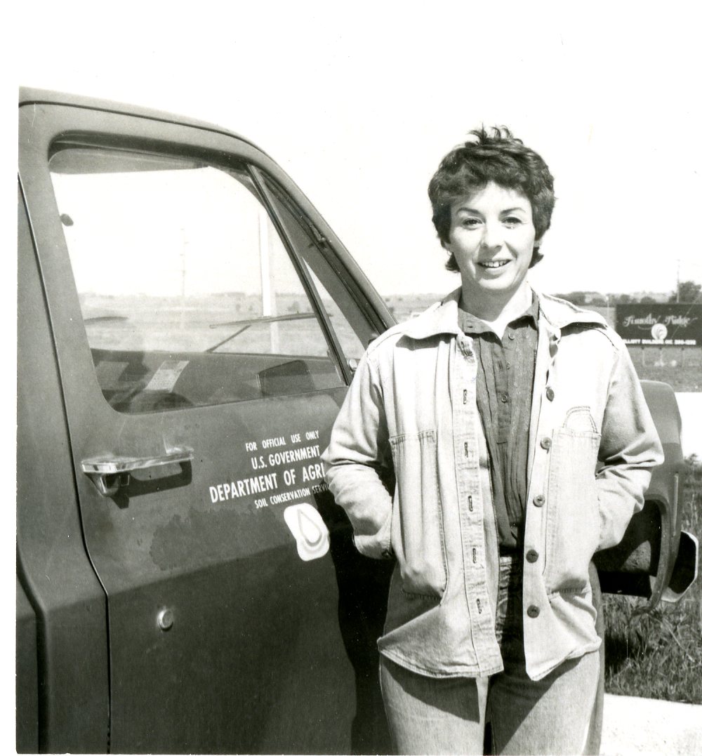 Woman Smiling in Front of SCS Truck